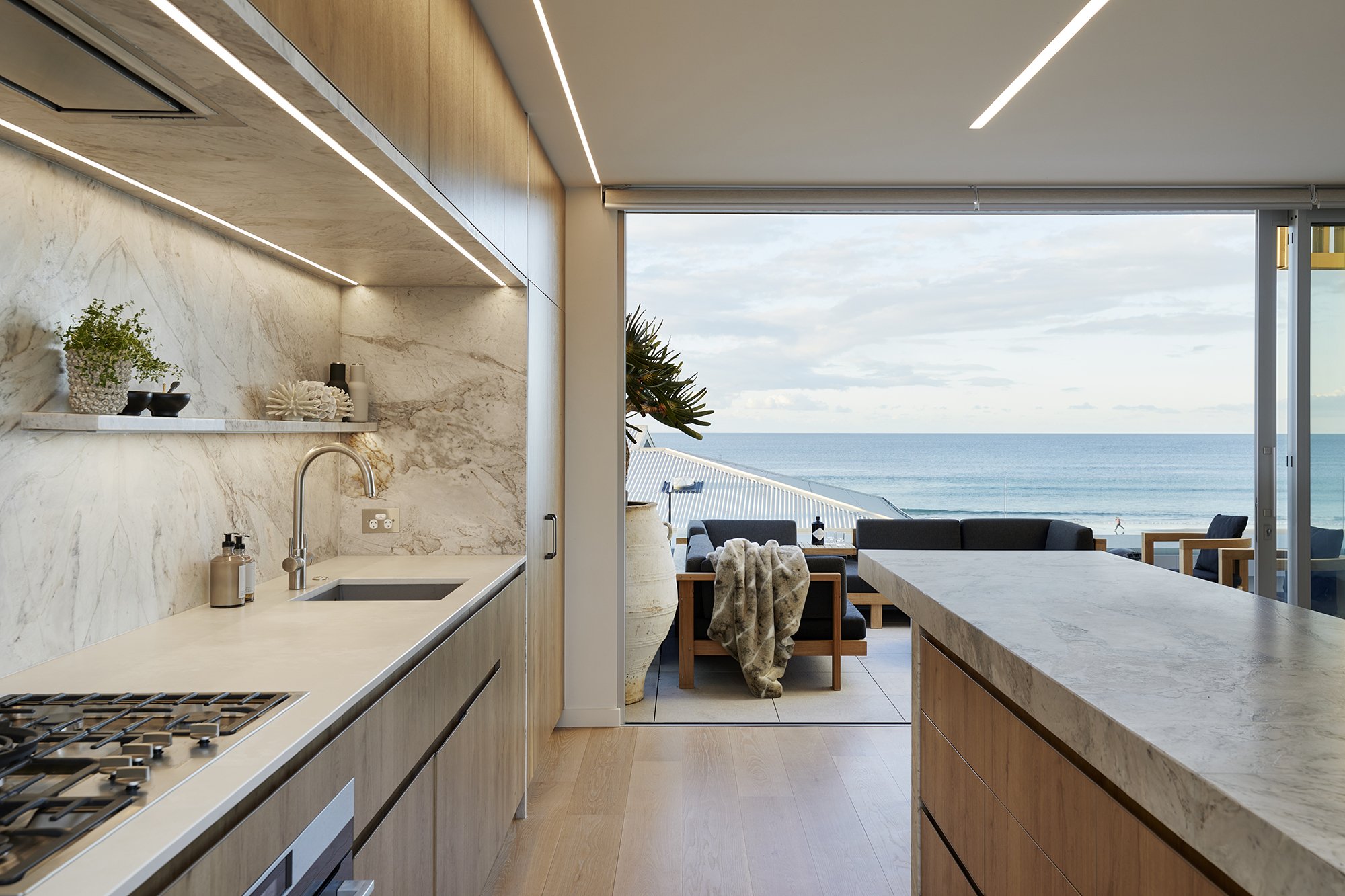 Exterior of Surf’s Edge Tauranga home with expansive glazing framing Mount Maunganui coastline views
