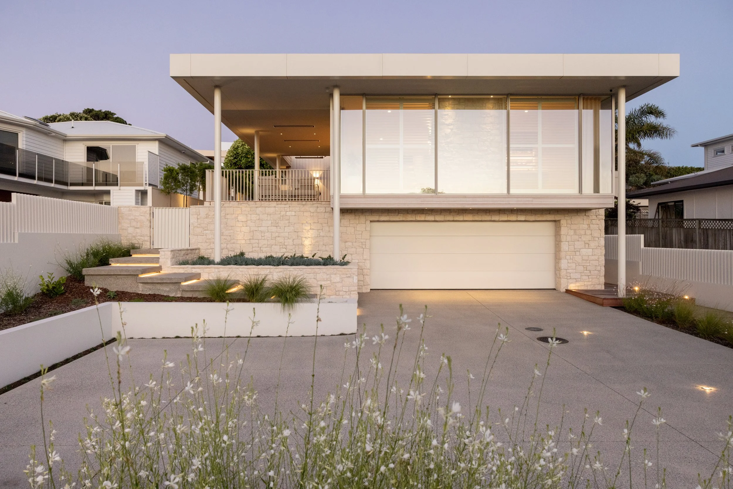 Roadside facade of Palm Springs Mount Maunganui home renovation with natural stone and timber