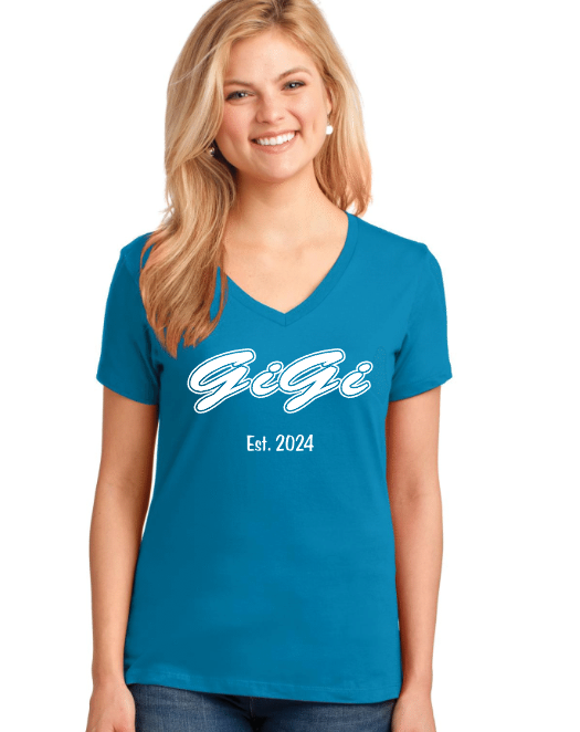 Young woman with blonde hair smiling, wearing a blue T-shirt with white text that says "Gigi" and "Est. 2024".