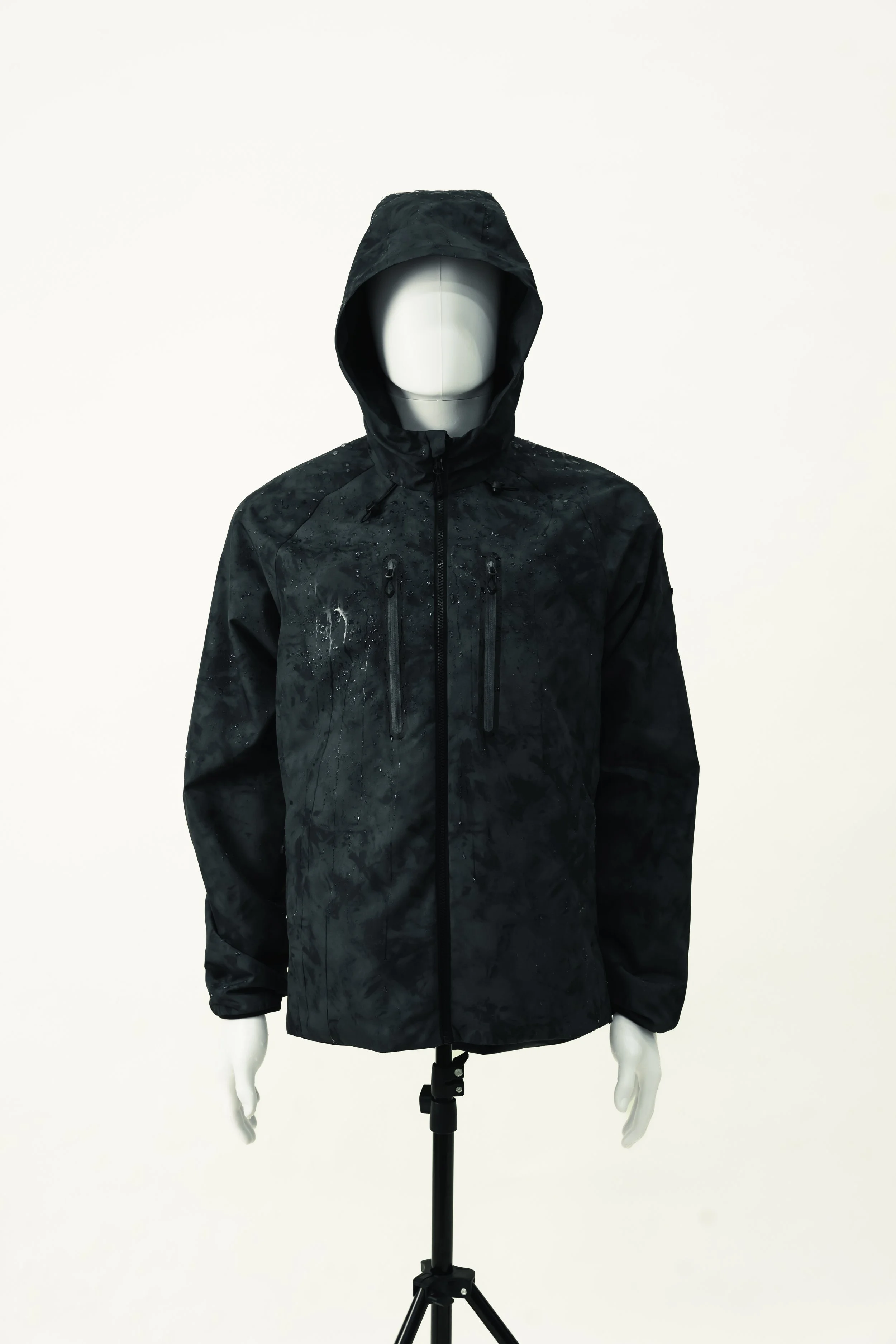 Black hooded waterproof jacket on a mannequin with a blank face, placed on a stand against a plain background.