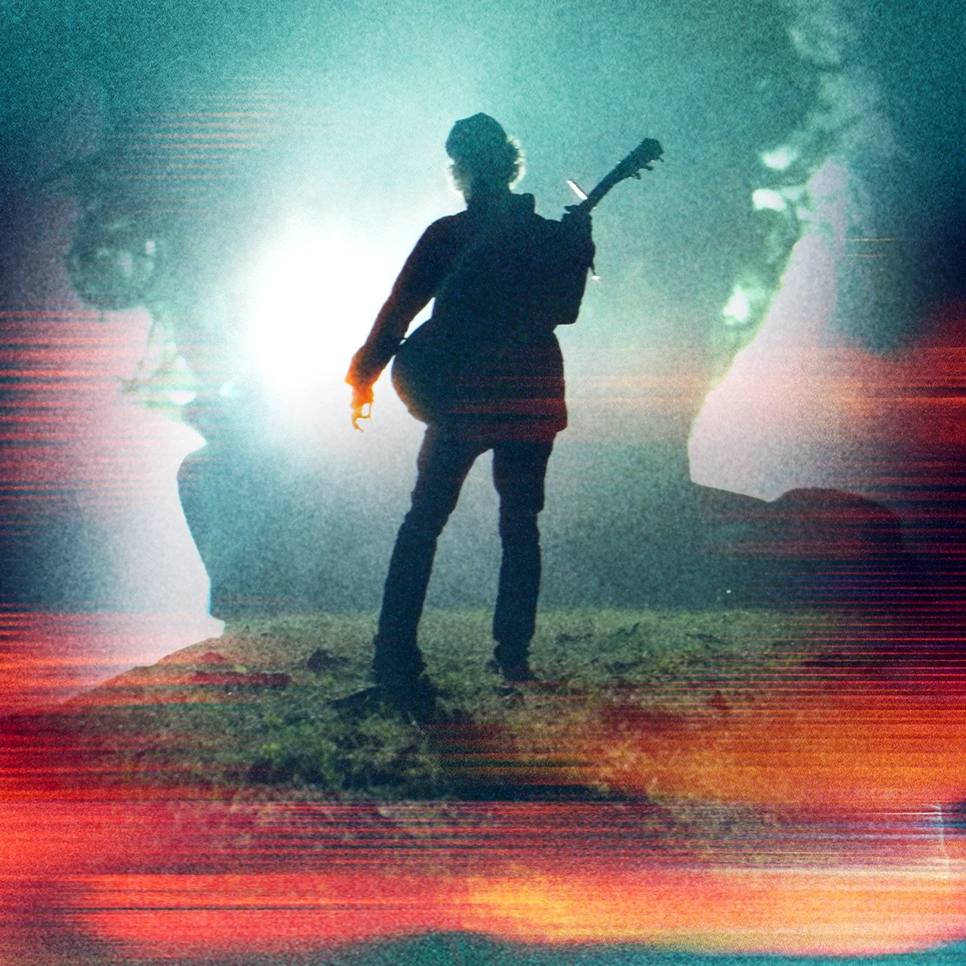 A silhouette of Seattle musician, Jon Rimmerman, frontman for band, arms around the world,  stands on grass in the moon light holding a guitar.  A colorful abstract overlay and face images in the background.