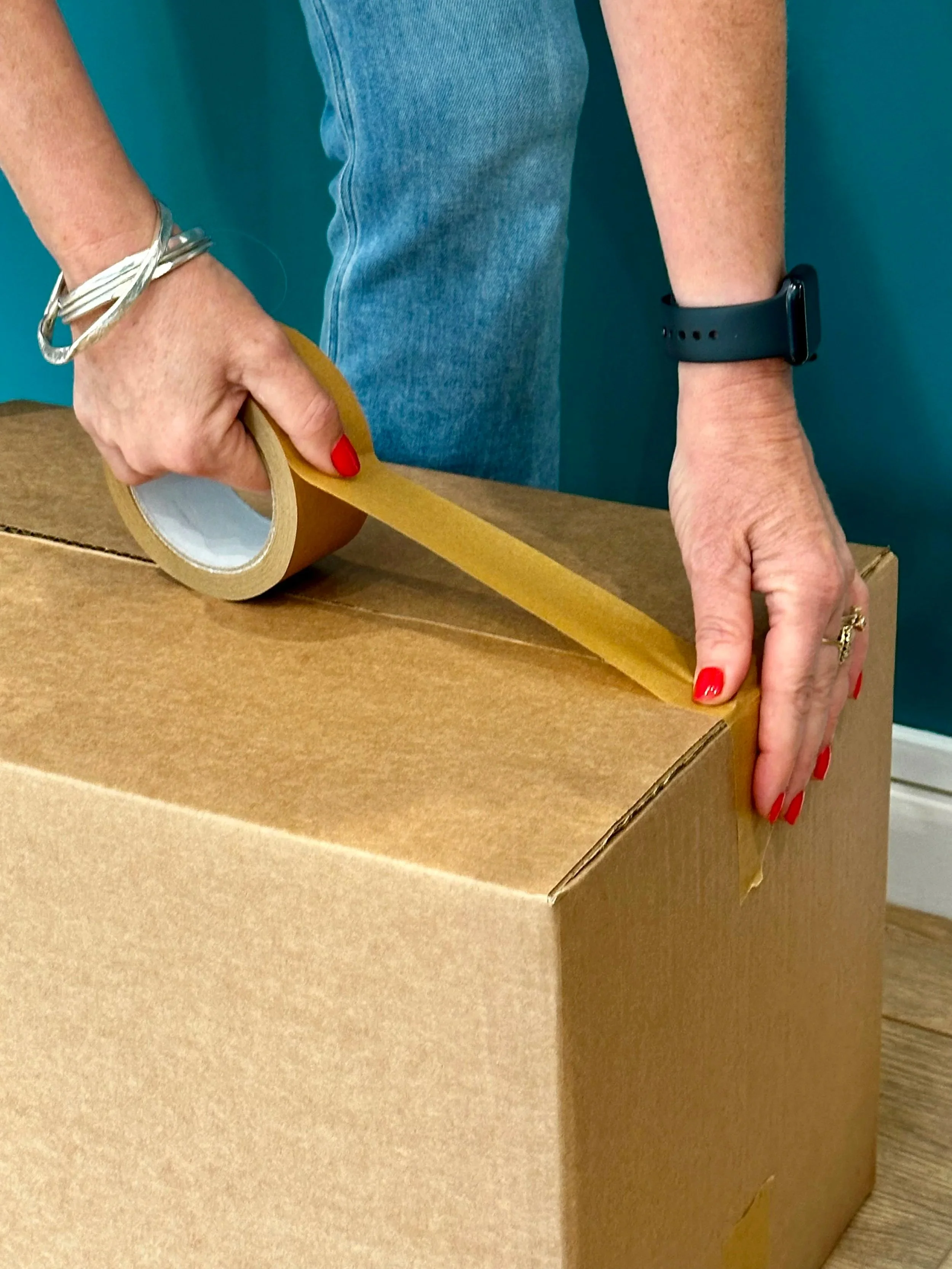 Image of a box of precious items being packed for storage, as part of the decluttering phase before a property is marketed