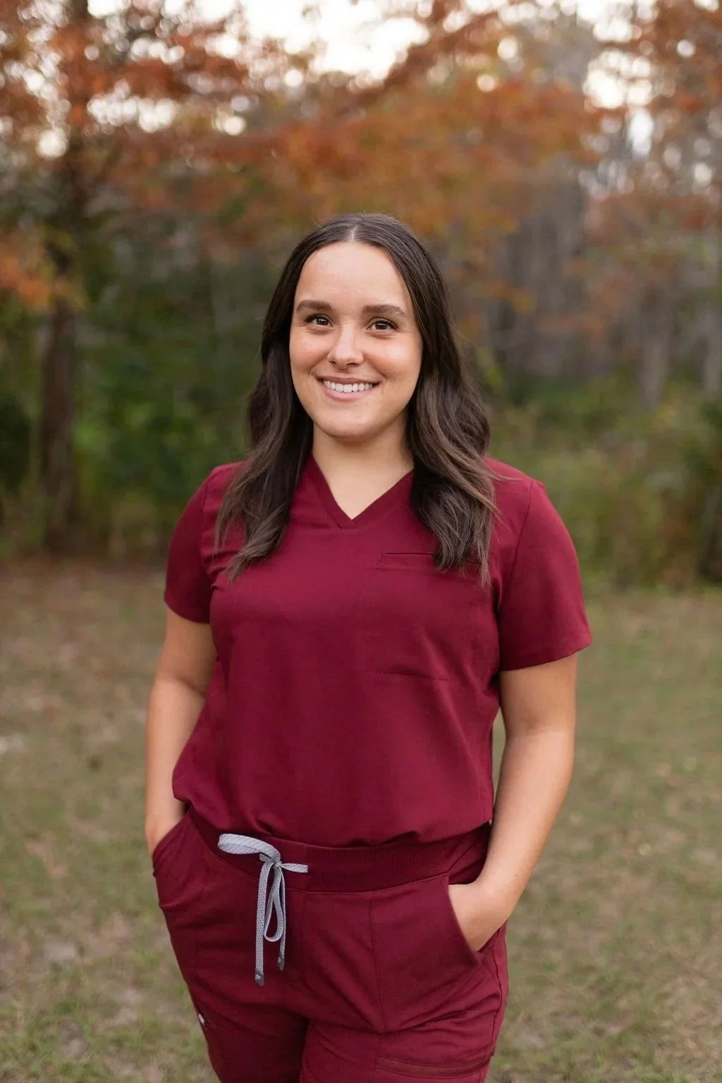 Lactation counselor with long dark hair wearing scrubs outdoors, meet your counselor page for lactation counseling services in Winter Garden, Horizon West, and Orlando.