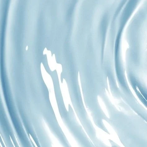 Close-up of swirling light blue and white water or liquid surface