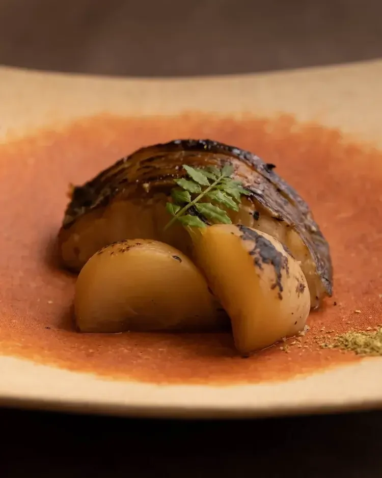Kaiseki-style dish featuring a piece of roasted fish.