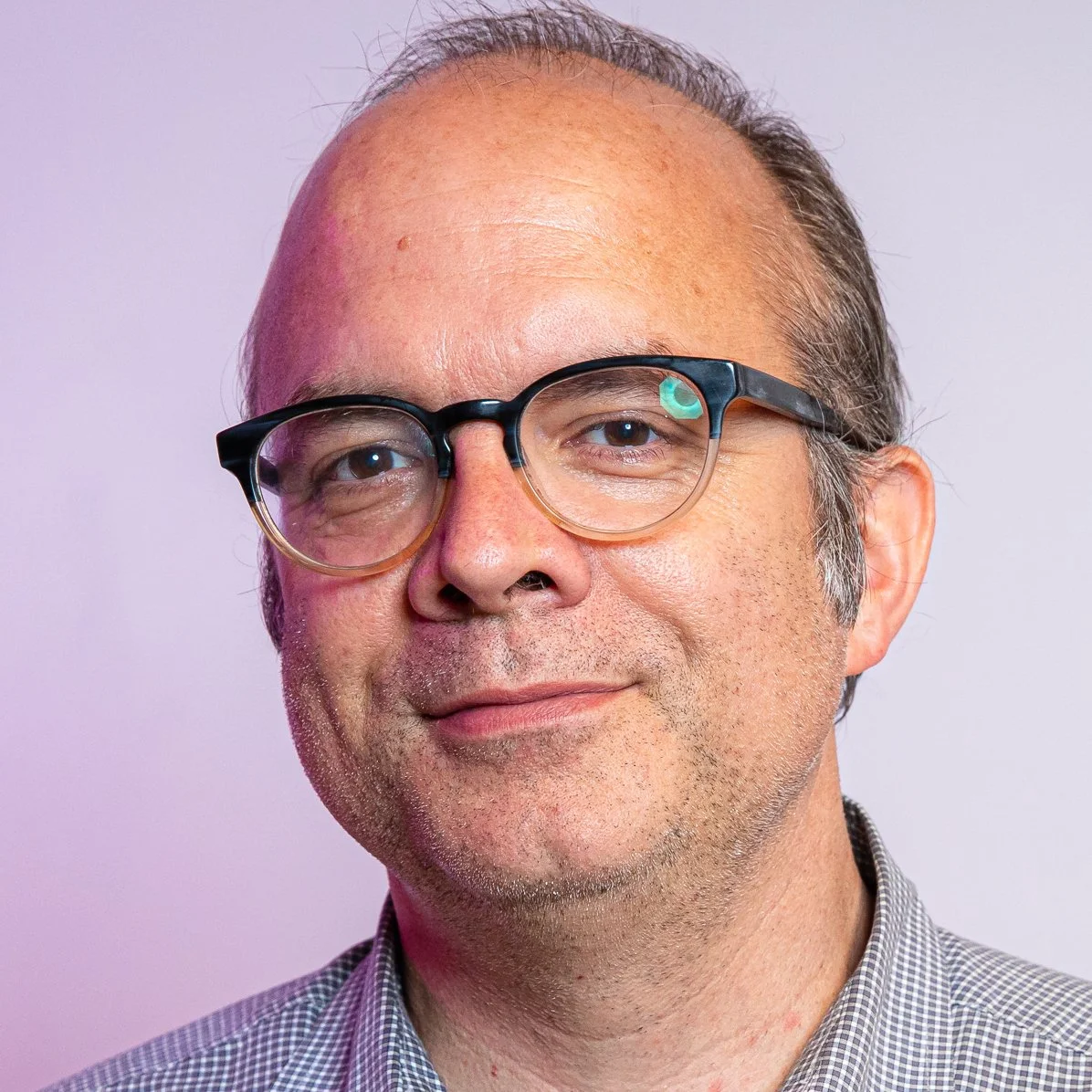 Will Hines with glasses and short brown hair smiling at the camera.
