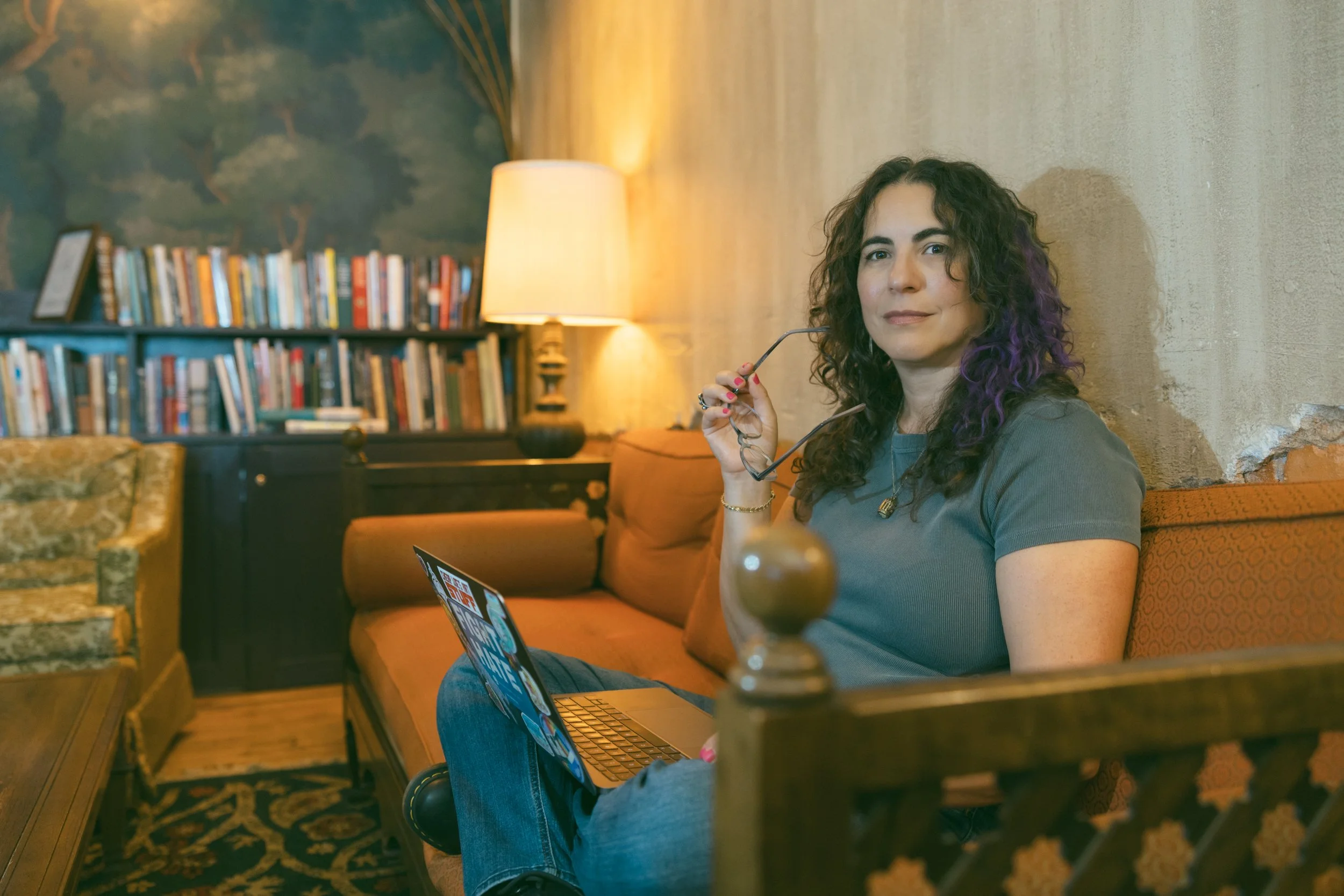 Samantha Pollack with a laptop on a couch