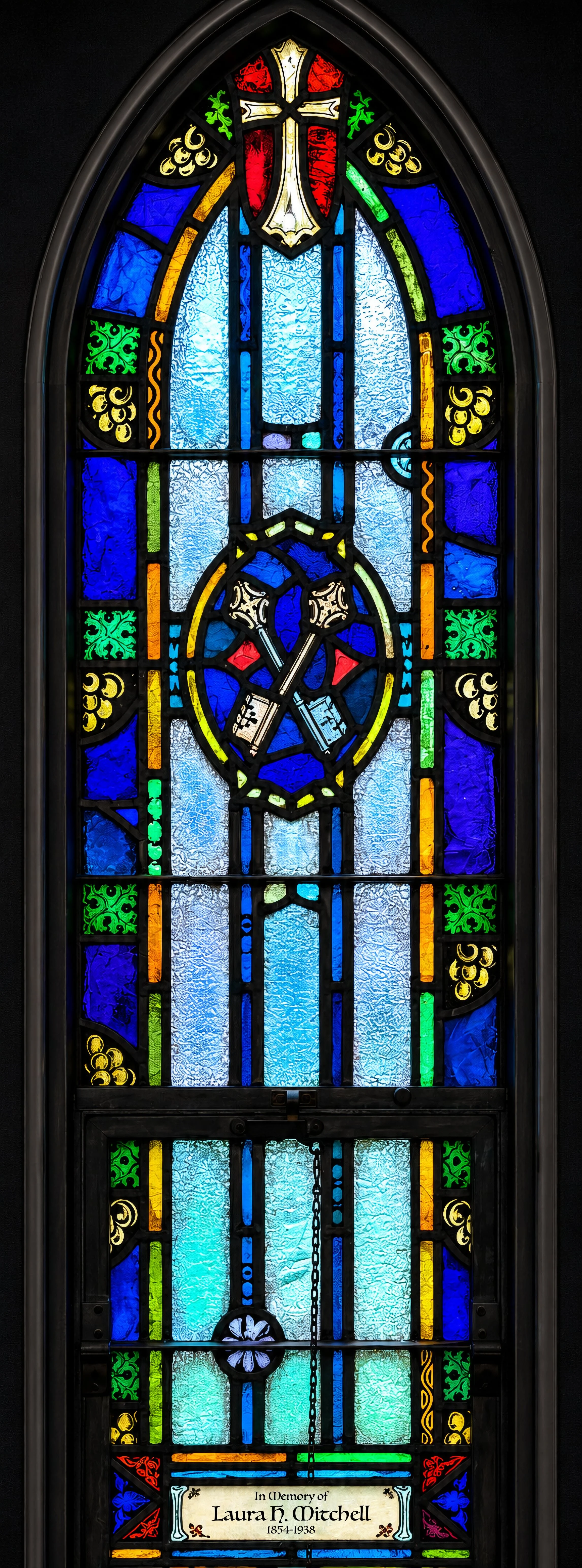 In the chapel vestibule, the two memorial windows here honor women who were members of St. Peter's Mission at its 1900 organization. Bishop Mitchell selected the symbols: On the Memorial Garden side, crossed keys for St. Peter, to whom Christ said, "