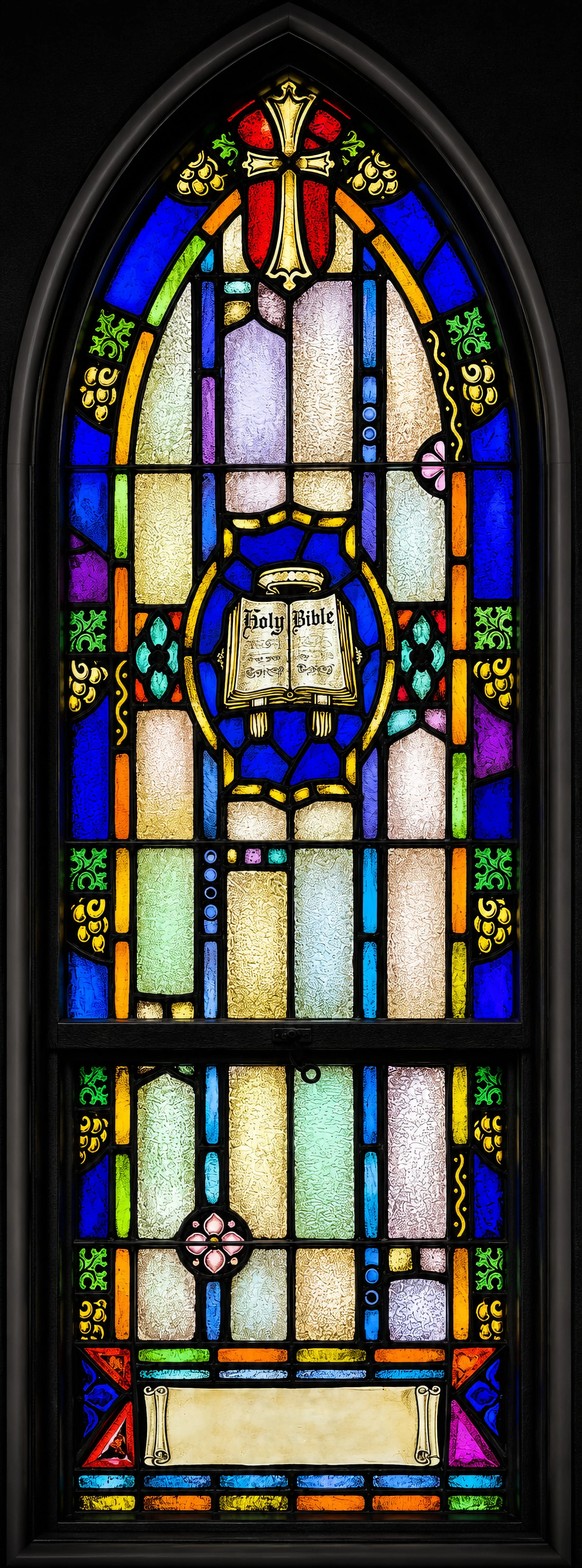 Two smaller windows on chapel side wall, designed by Bishop Mitchell, name the twin centers of our common life: To the left, an open Bible inscribed "Holy Bible" for the preaching of the Word.