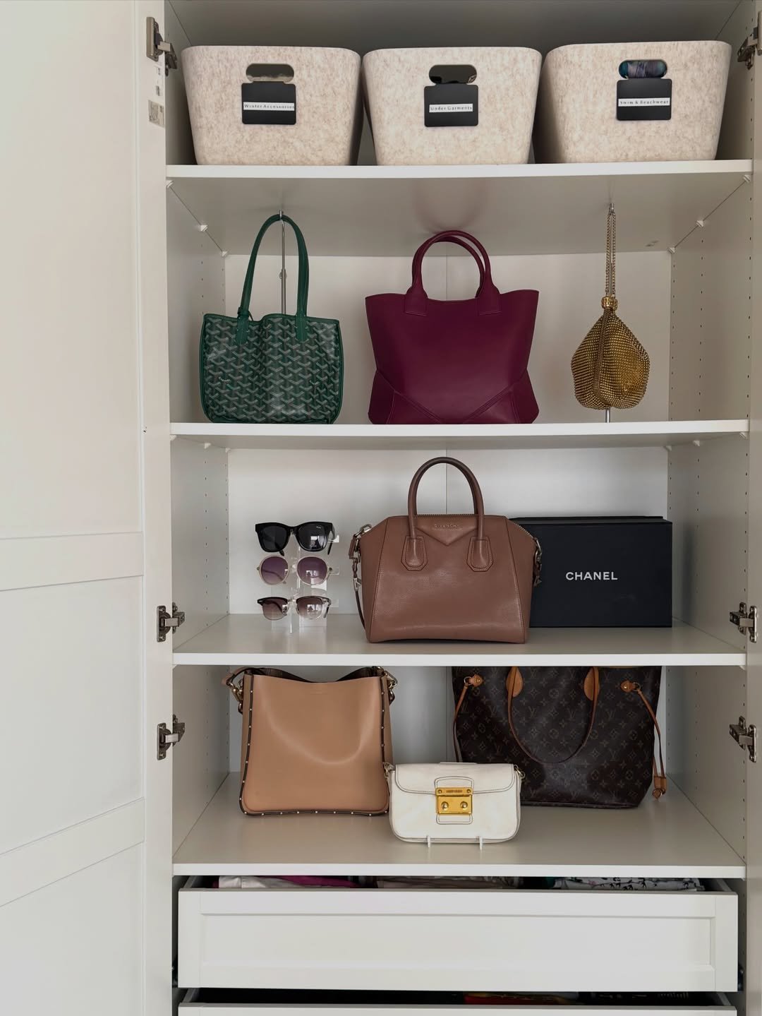 luxury bag organized in a white closet
