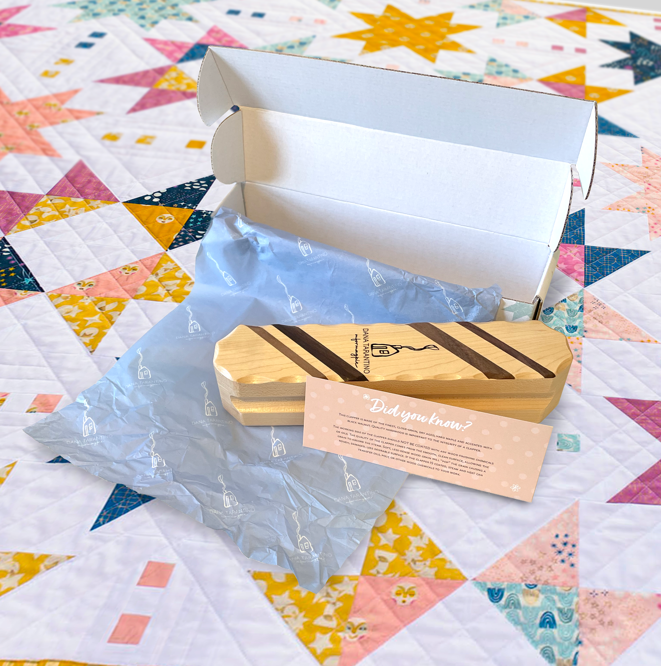 Decorative wooden box and packaging on colorful quilt