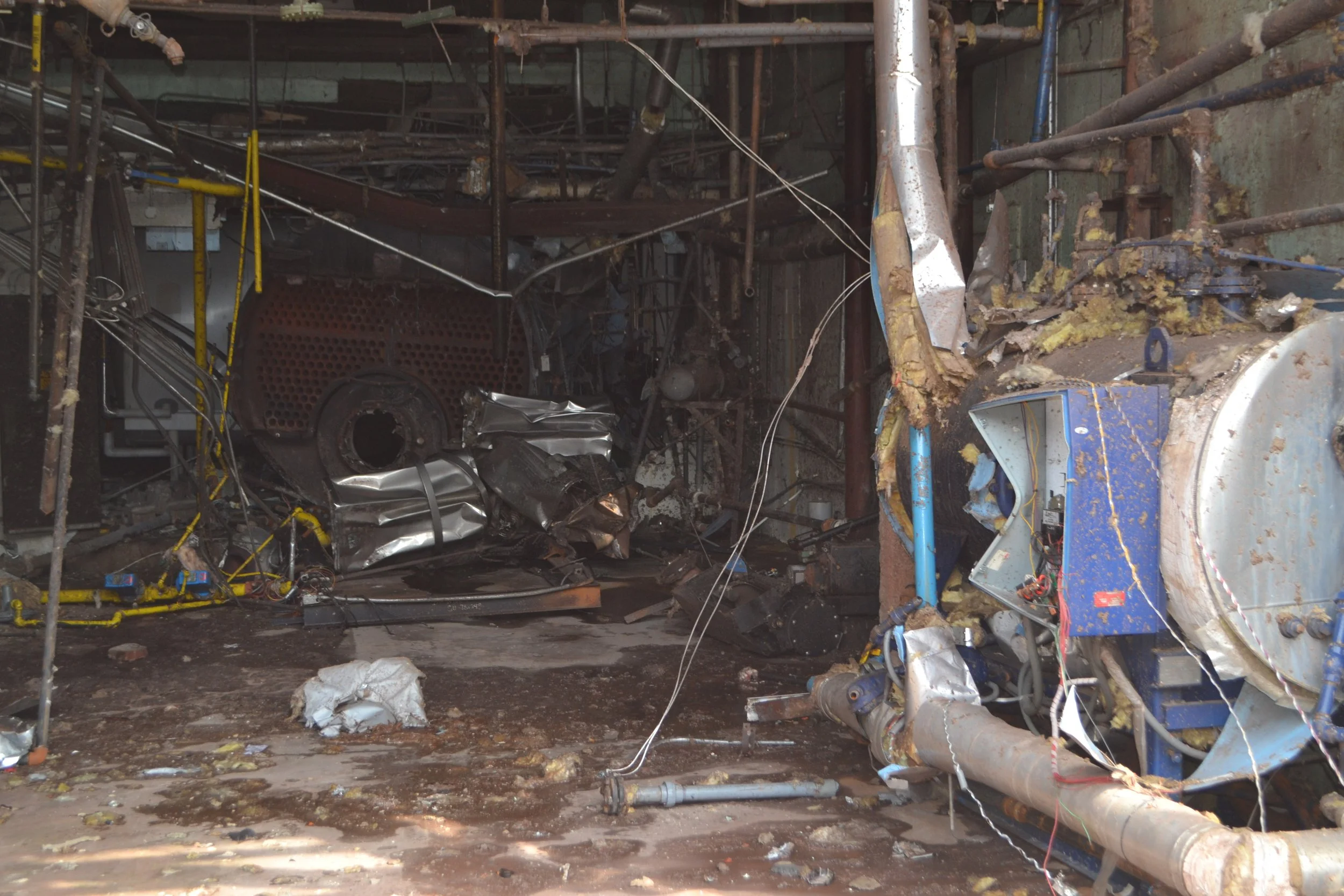 Image of the boiler pushed through the wall, impacting the process tanks (not visible).