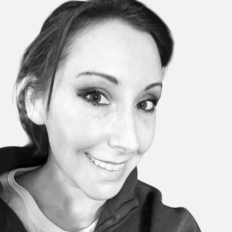 Millicent Martin. Close-up black and white photo of a smiling woman with short hair, wearing a hoodie.