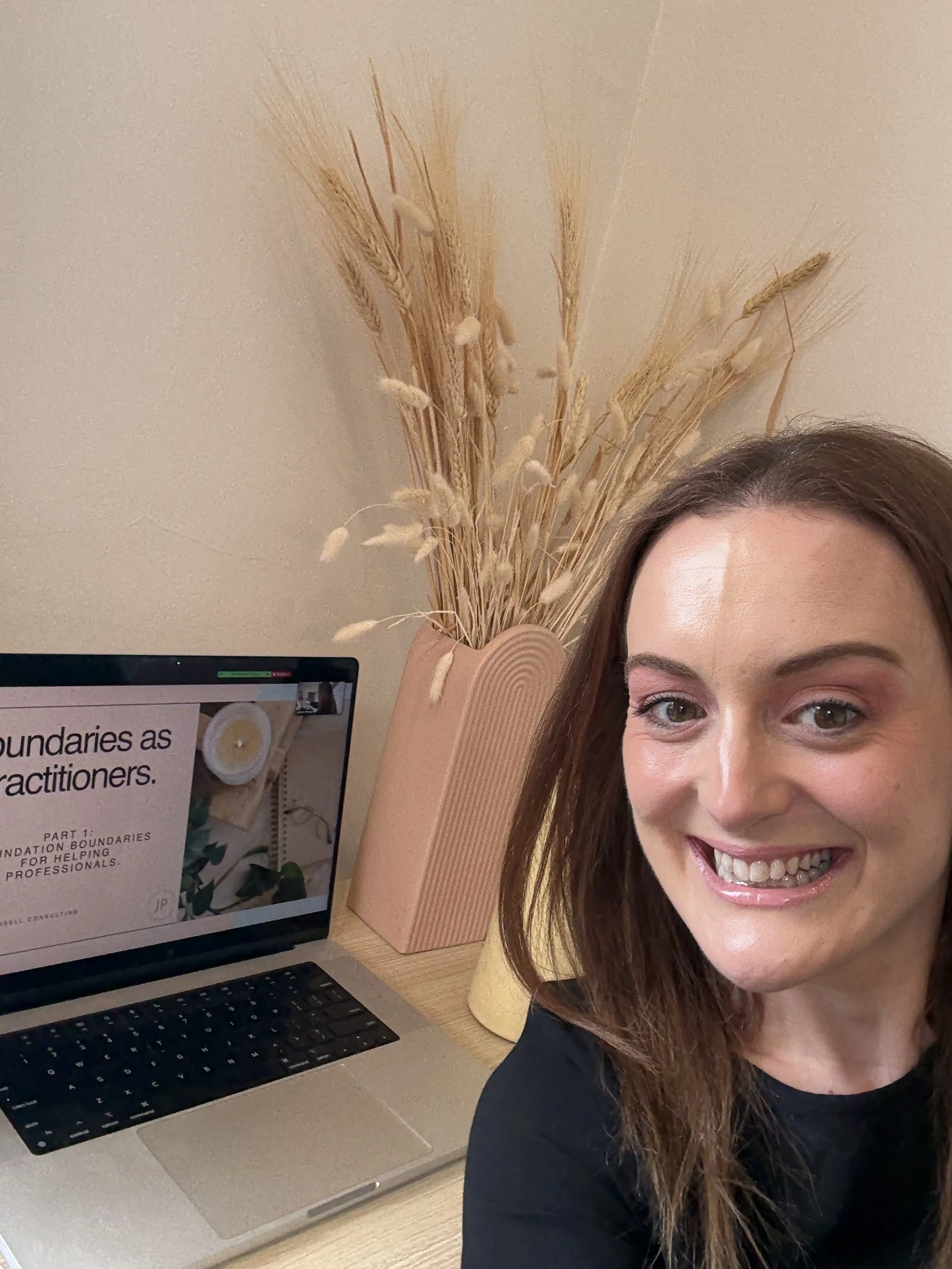 Jazmin Pursell delivering Boundaries Masterclass Training, smiling in front of computer