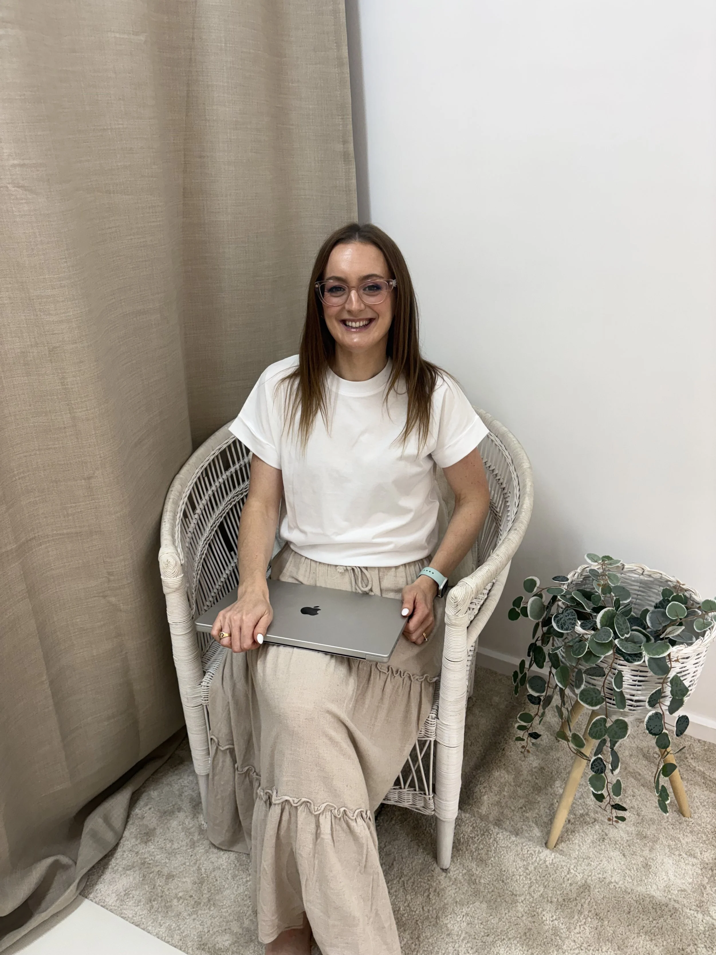 Jazmin Pursell sitting down on chair with MacBook
