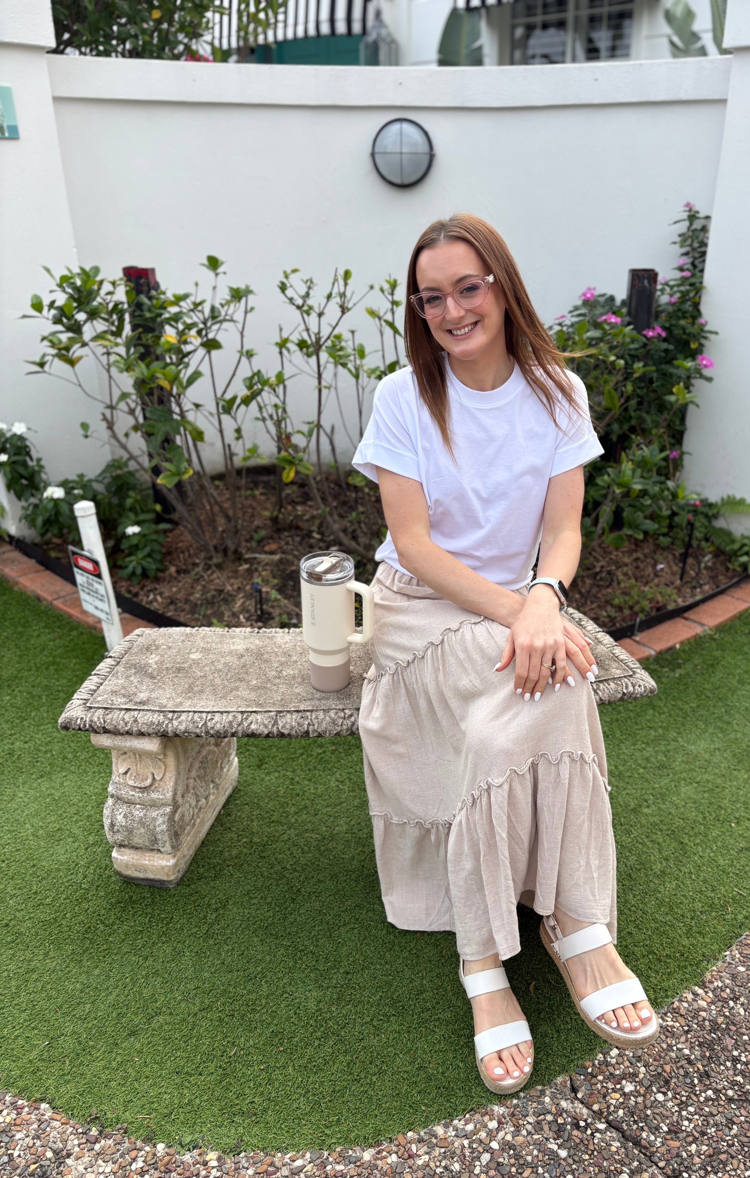 Jazmin Pursell smiling and sitting on bench