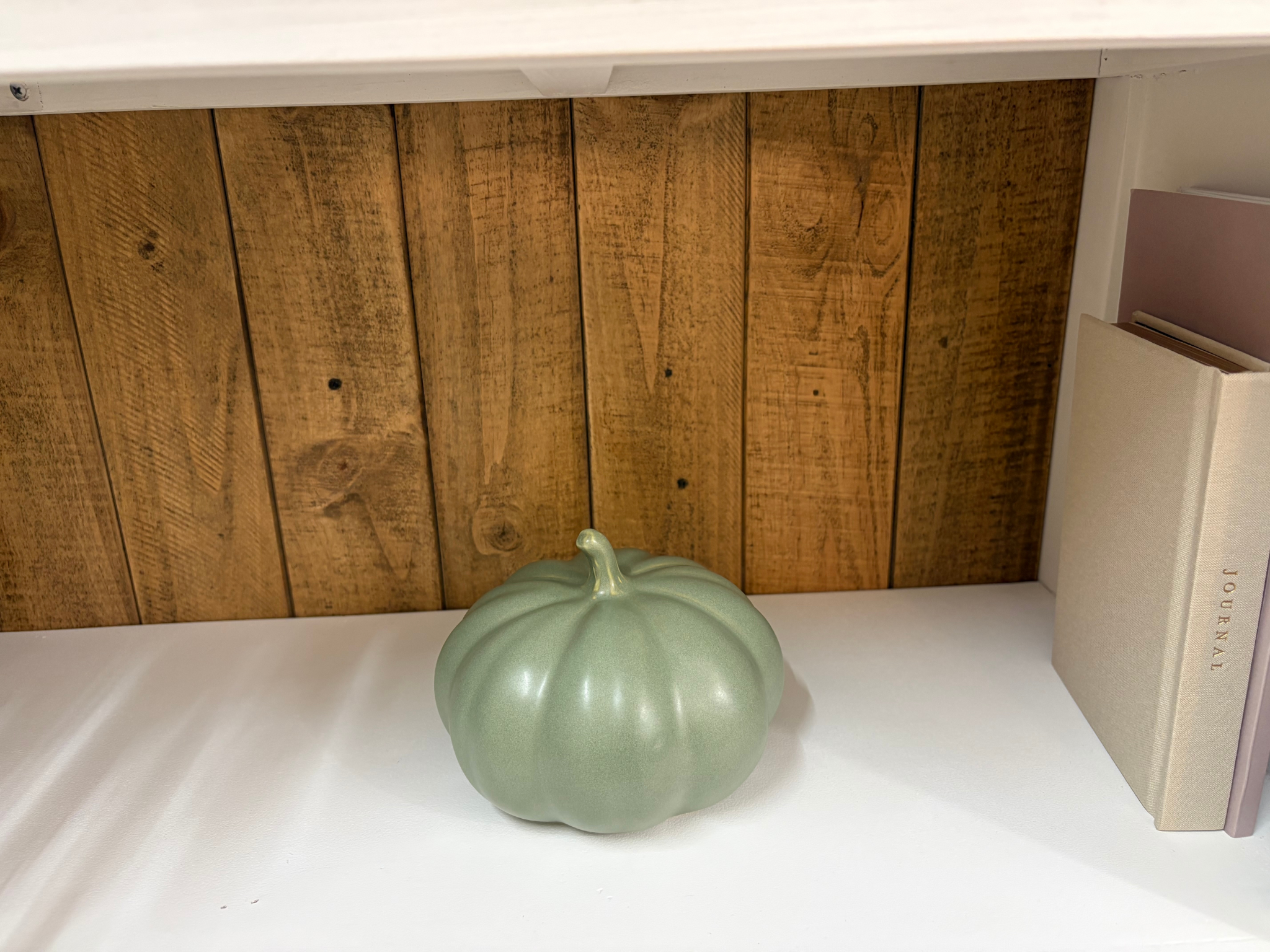 Jazmin Pursell Consulting calming office decor light green pumpkin and journal on shelf