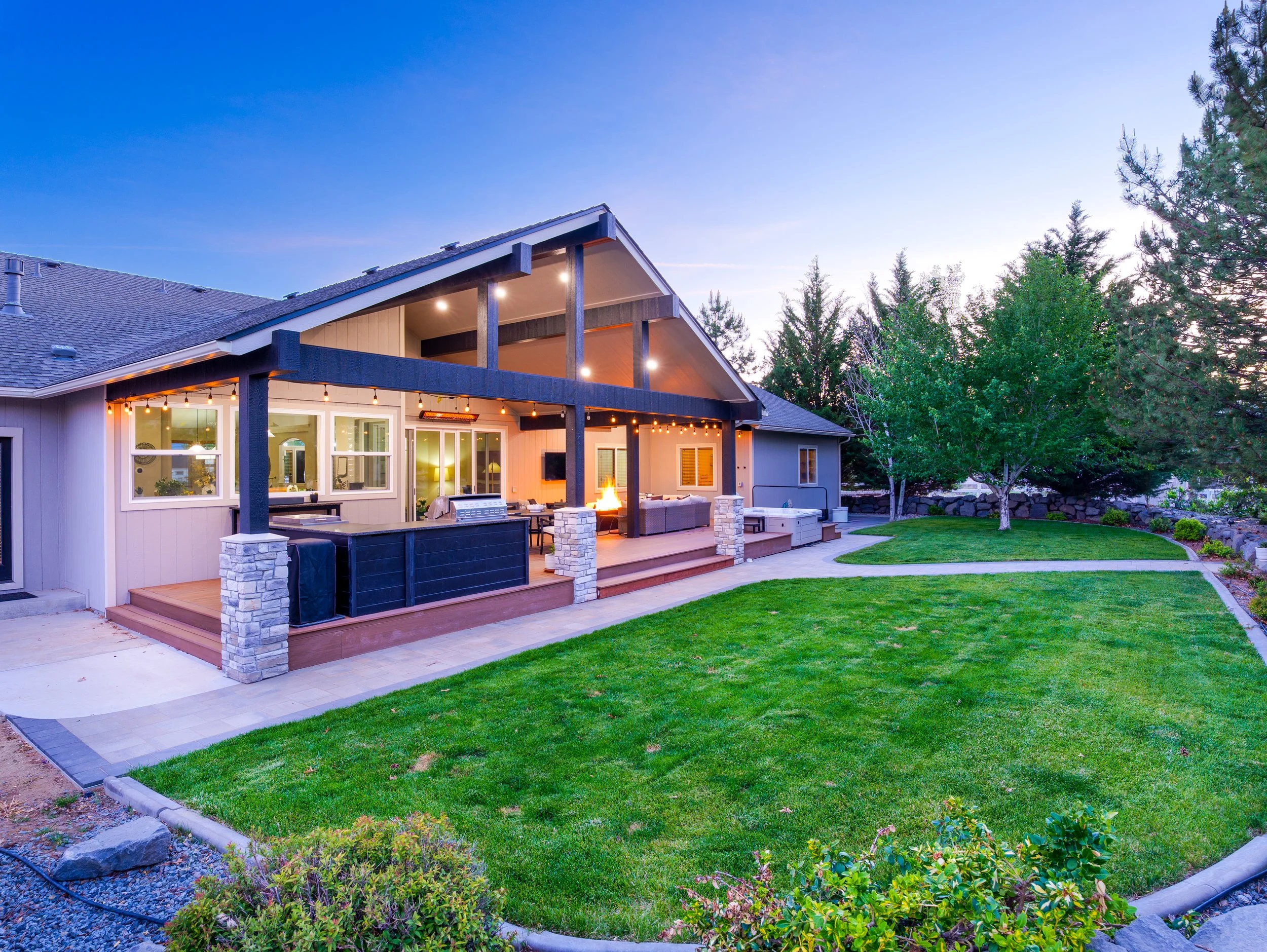 Twilight exterior with warm interior glow against dusk sky, Northern Nevada