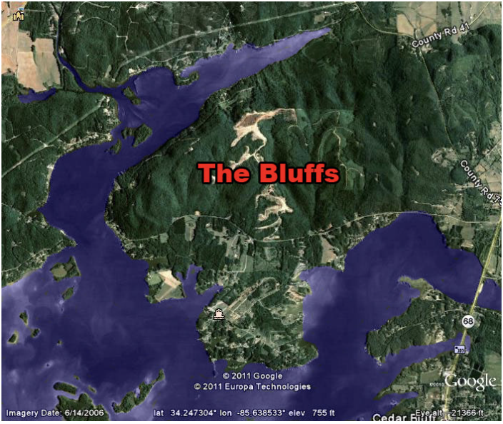 Satellite map showing an area called The Bluffs surrounded by bodies of water and green forested land, with roads including County Rd 41 and County Rd 68.