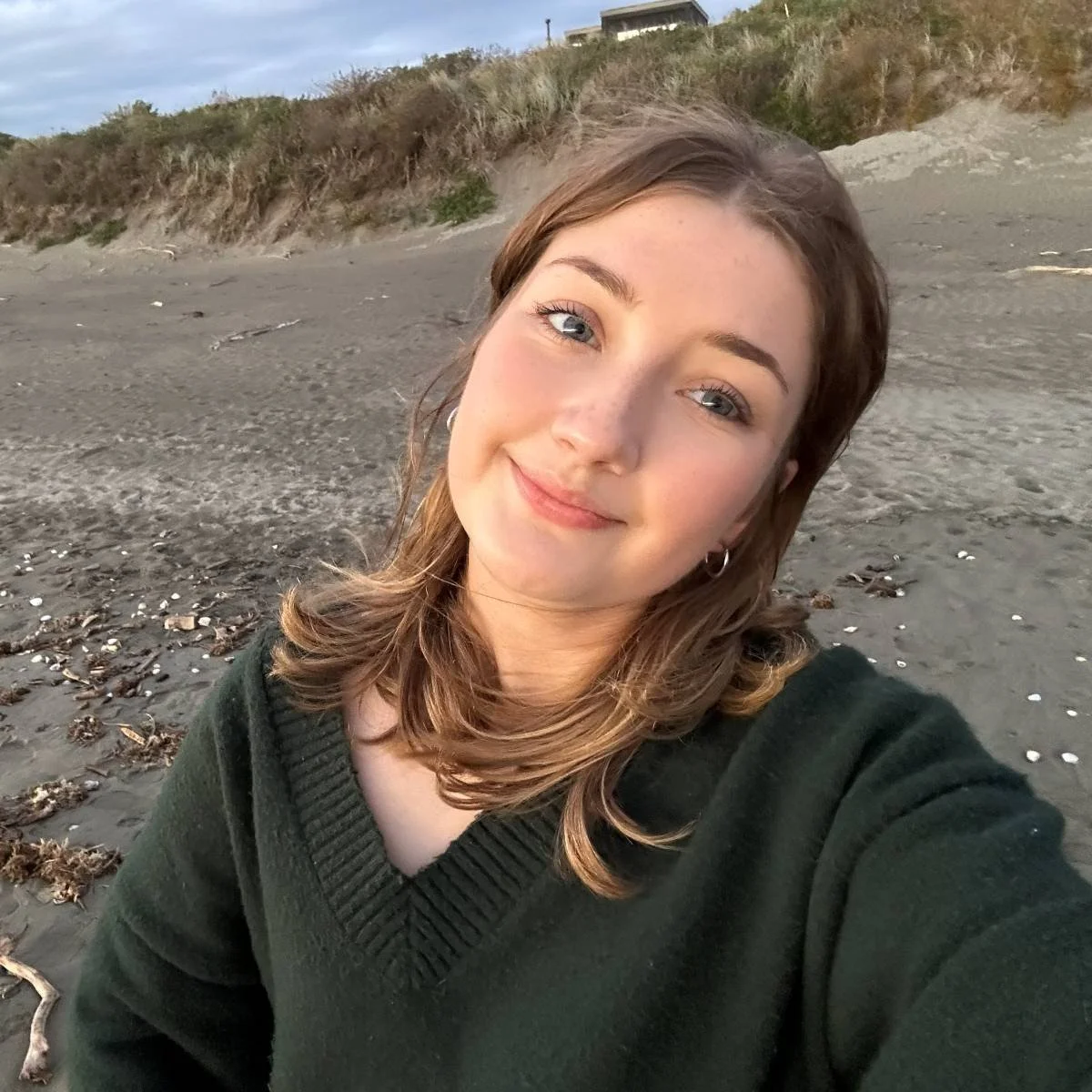 Young woman on the beach smiling
