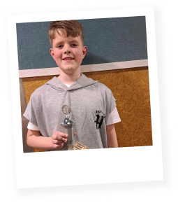 Boy holding dance trophy