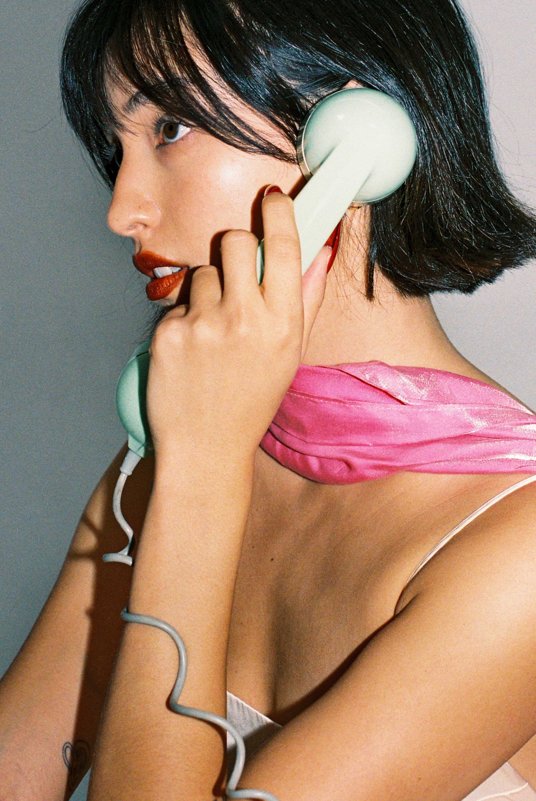 Retro girl talking on vintage phone teal