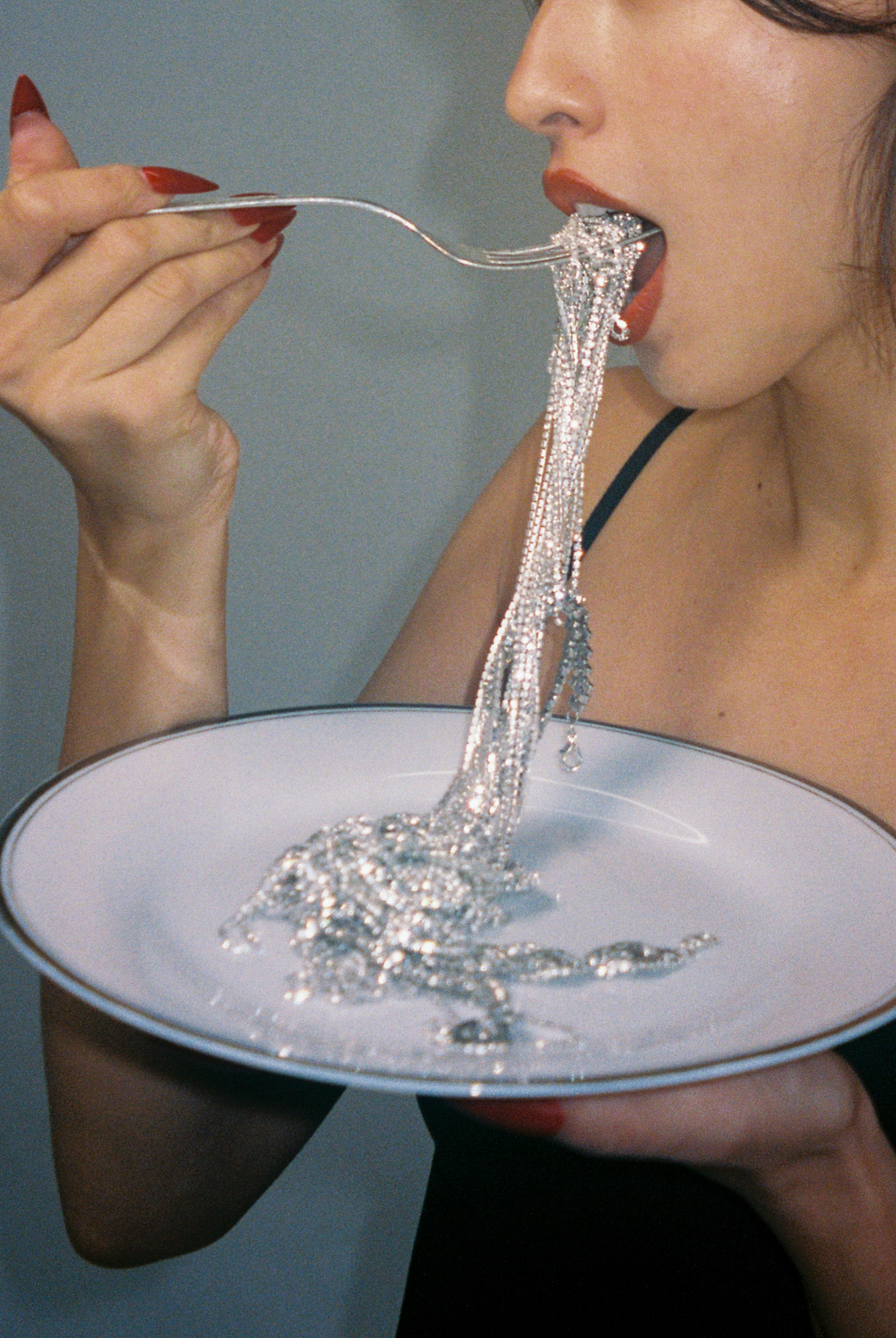 Red lipstick eating jewelry diamonds on plates