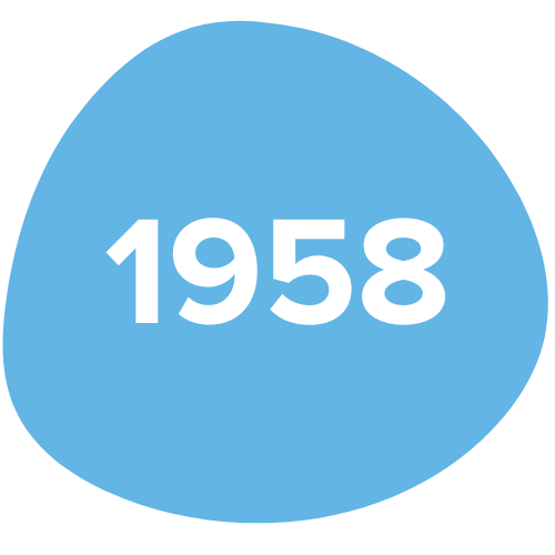 Blue circular badge with the year 1958 written in white text.