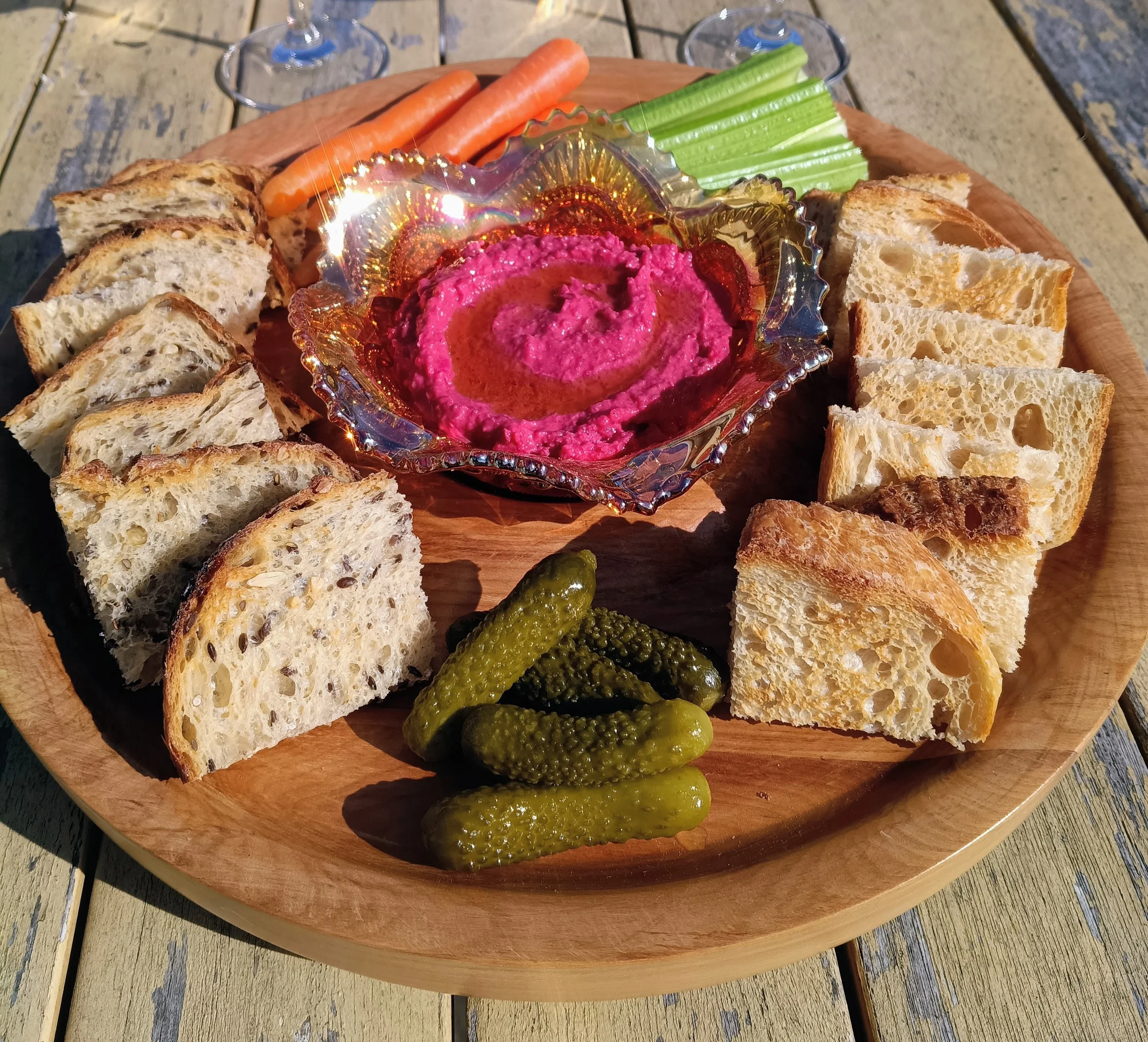 Vegan snack platter with toasted sourdough squares, beetroot hummus, vege sticks, healthy