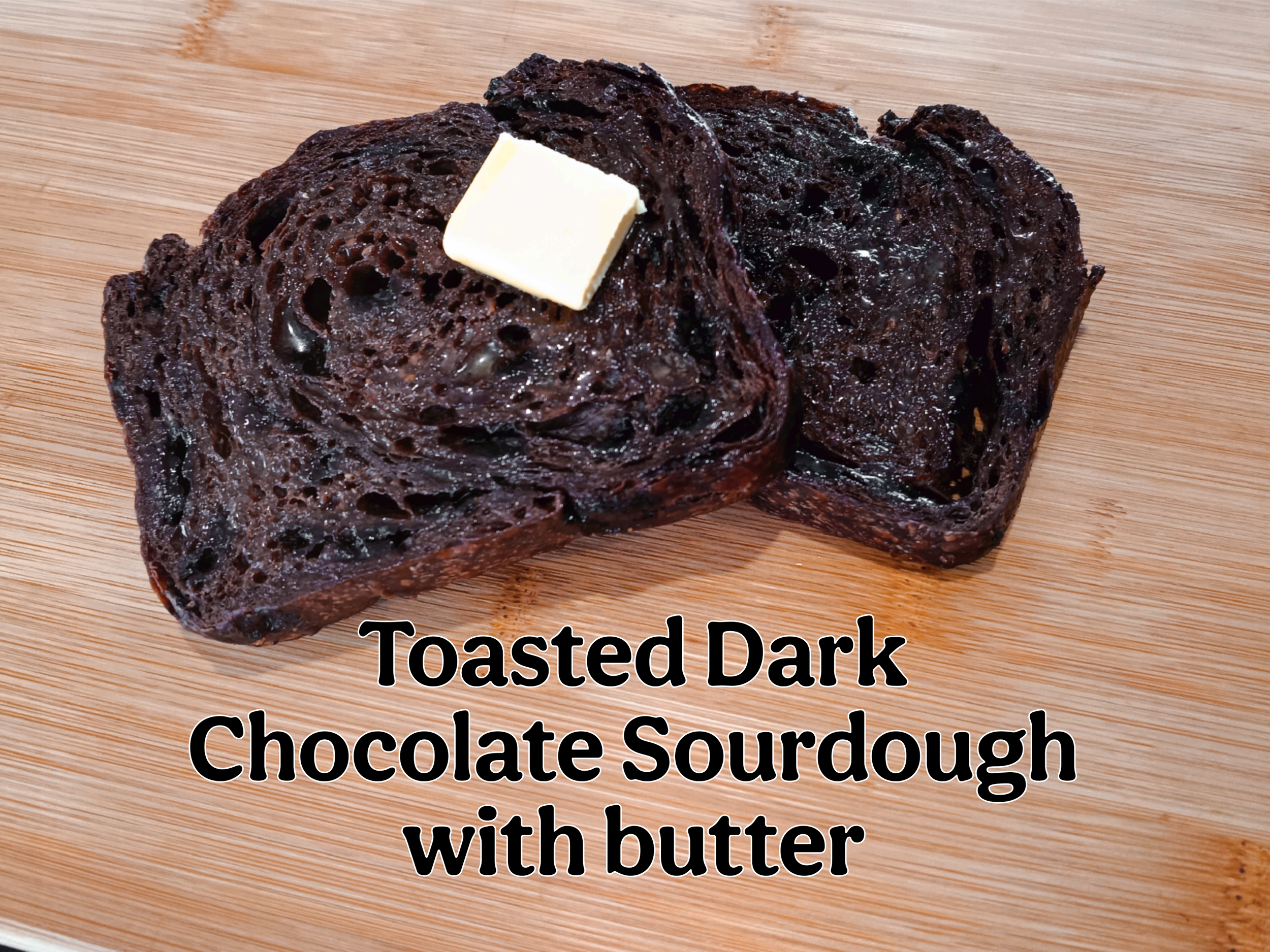 Two slices of toasted dark chocolate sourdough bread with a square of butter, serving suggestion, eat chocolate bread warm with butter, Kapiti Delicious Doughs