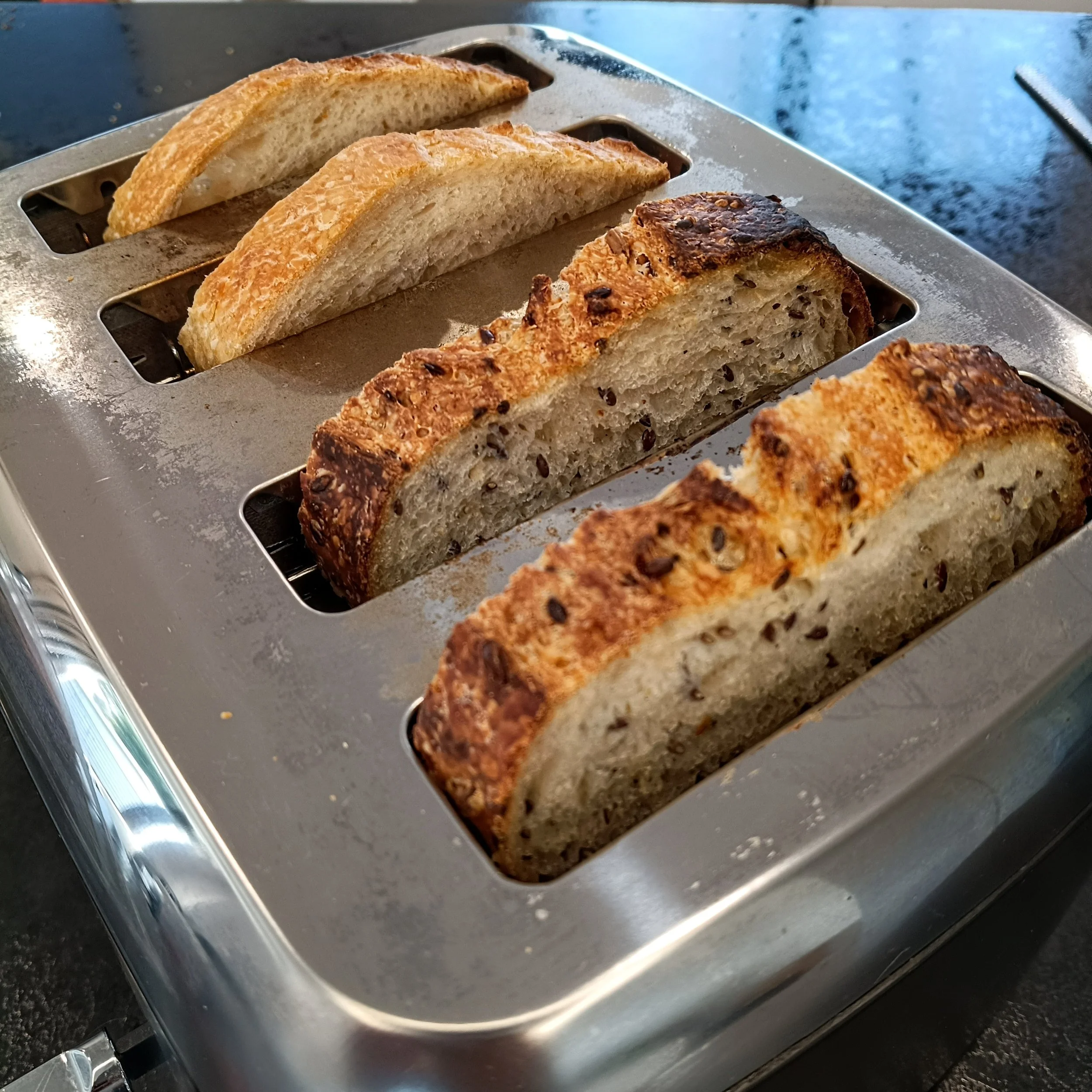 Slices of seeded and classic sourdough in a regular 4-slice toaster, fits perfectly.