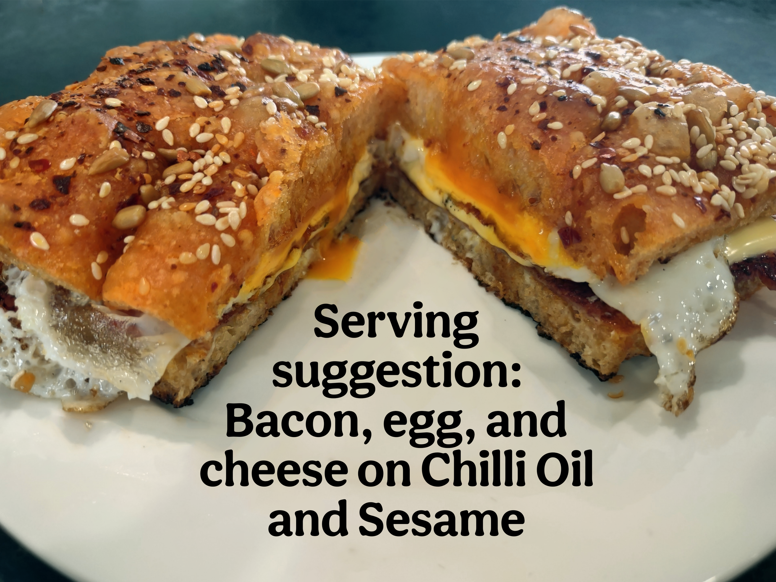 Bacon, egg, and cheese sandwich made with chilli oil and sesame sourdough focaccia by Meg at Kapiti Delicious Doughs.