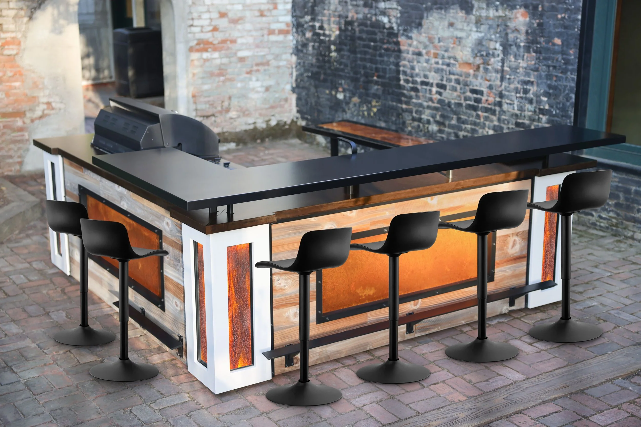Bar counter with five black bar stools and a cash register, set on a brick patio with rustic brick and wood wall in the background.