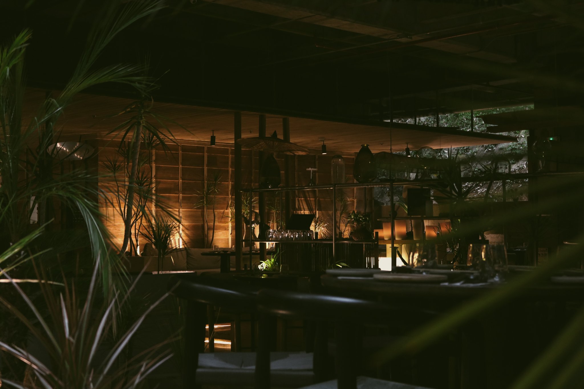 Modern restaurant interior featuring contemporary architecture, sculptural lighting, and designer furniture