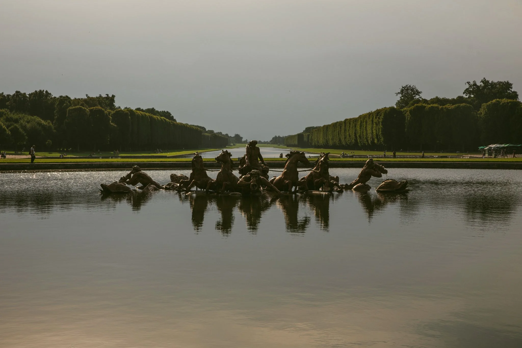 Ornate fountain in the gardens of the Palace of Versailles featuring classical sculpture and landscape design