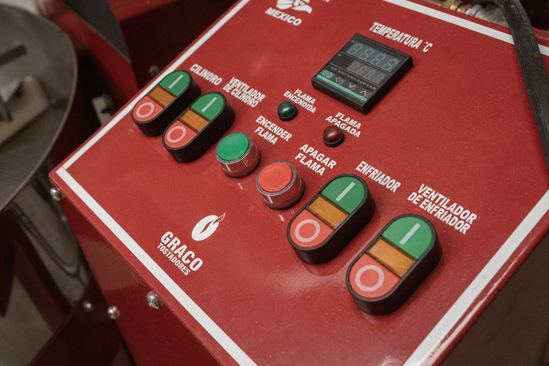 A close-up of a coffee roaster control panel used to process locally grown coffee in Chiapas.