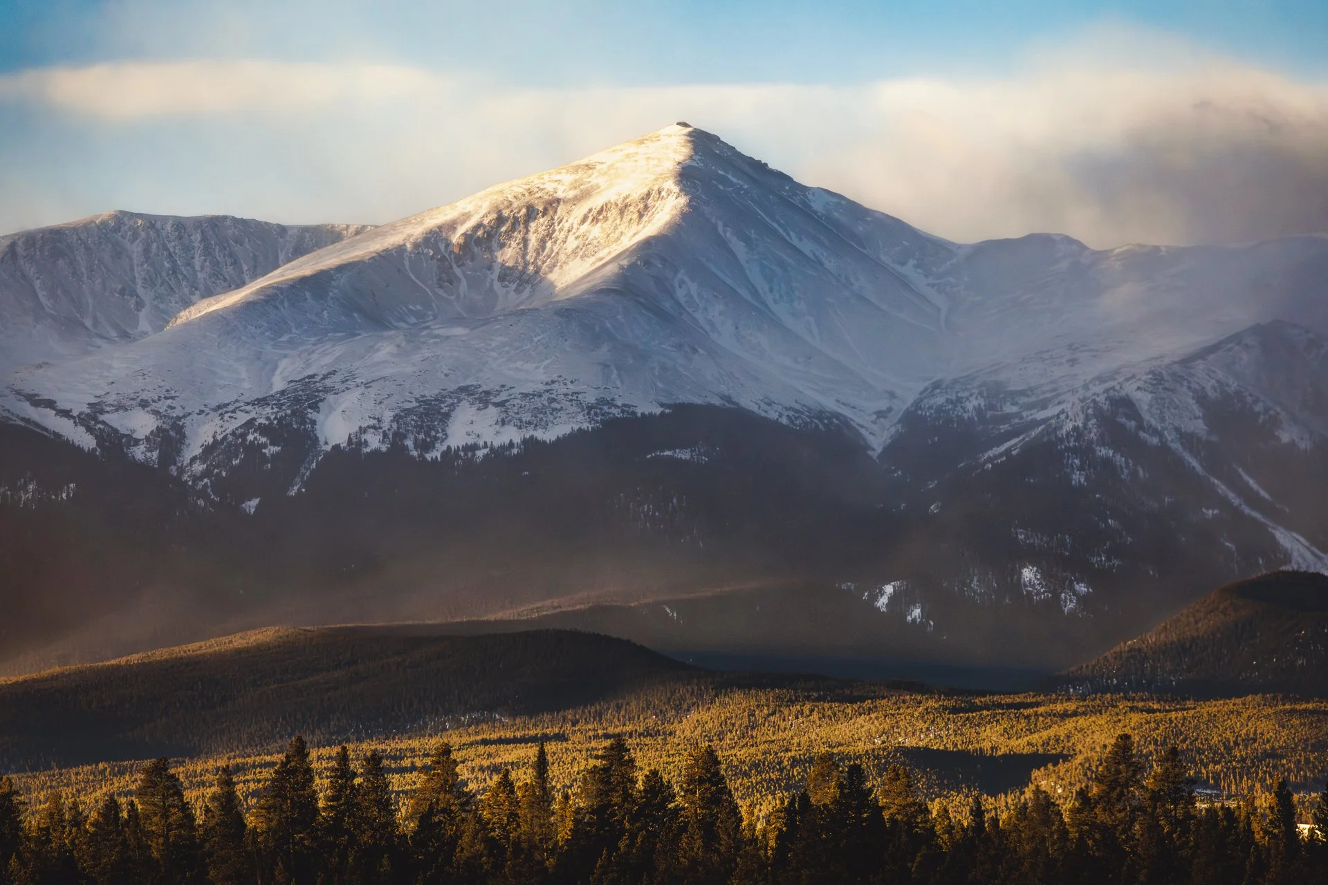 Early morning light hitting a lone snowy peak in the Sawatch Range during subzero temperatures.
