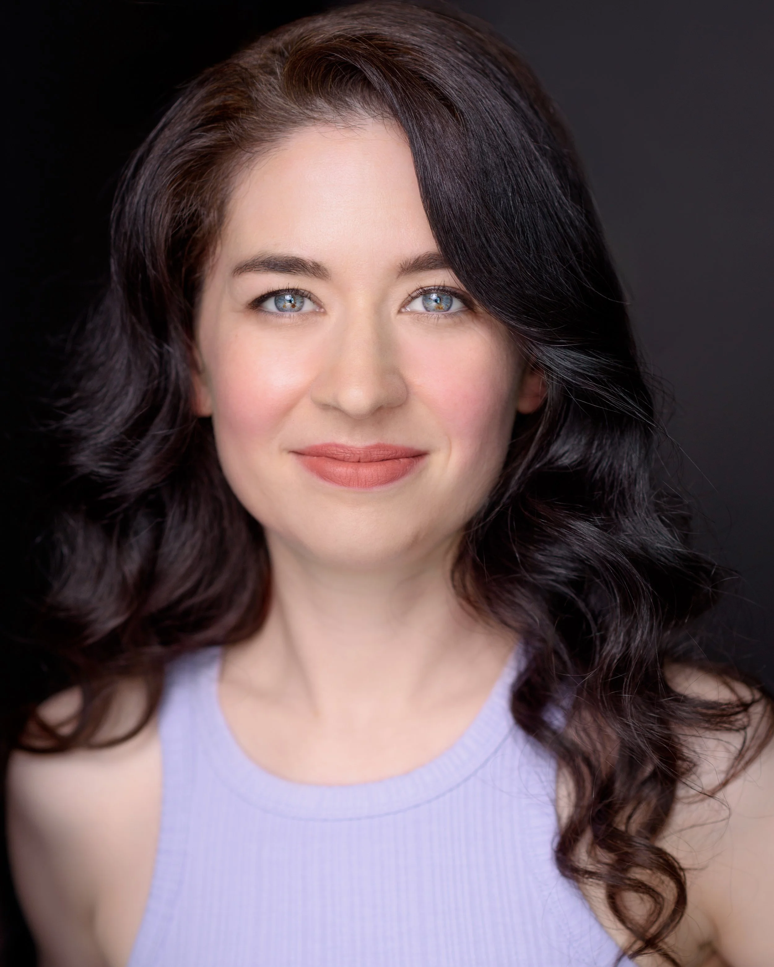 Serious headshot of Sydney pianist Lauren Carey Kevin facing camera in lilac top