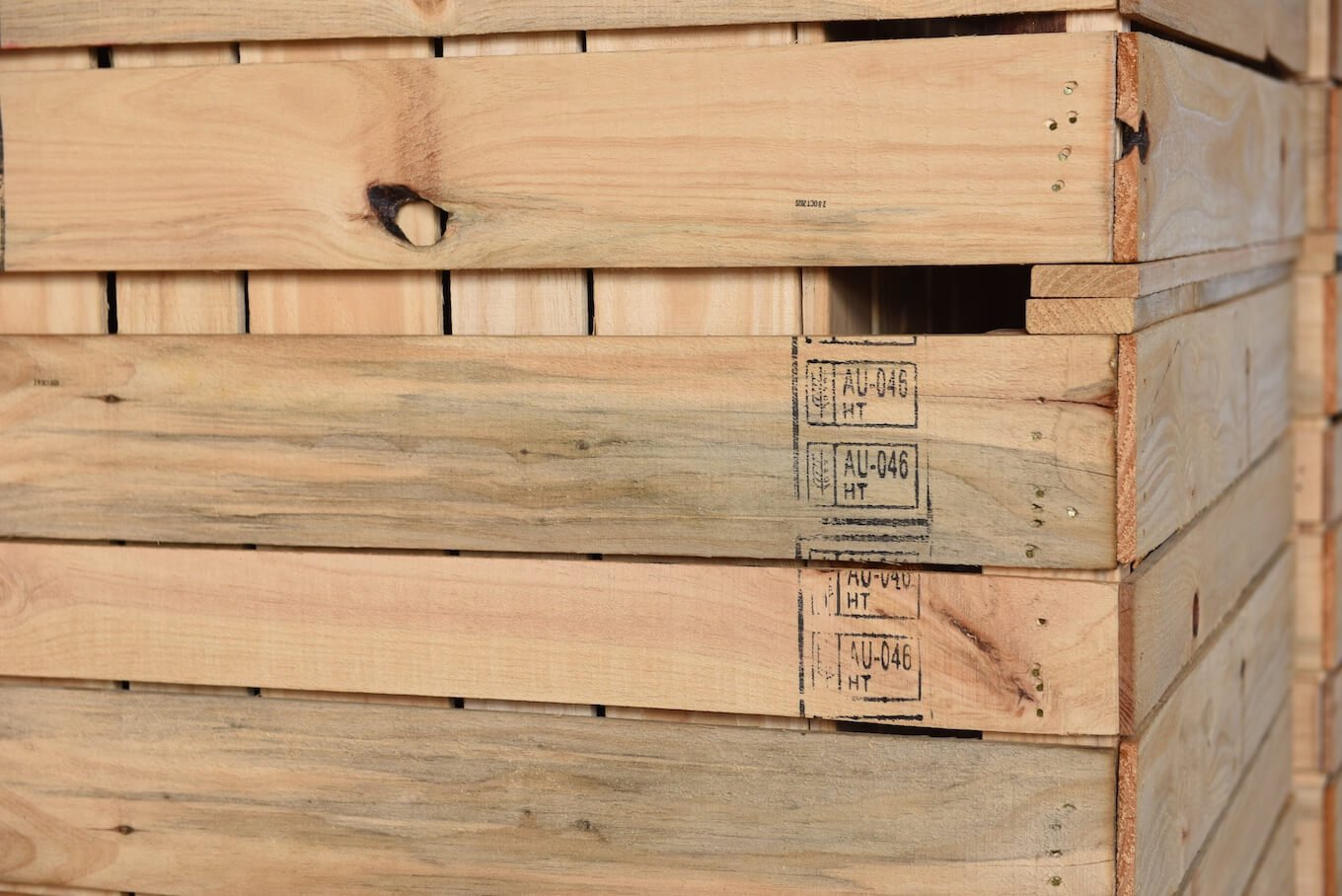 Stacked wooden pallets with printed labels.