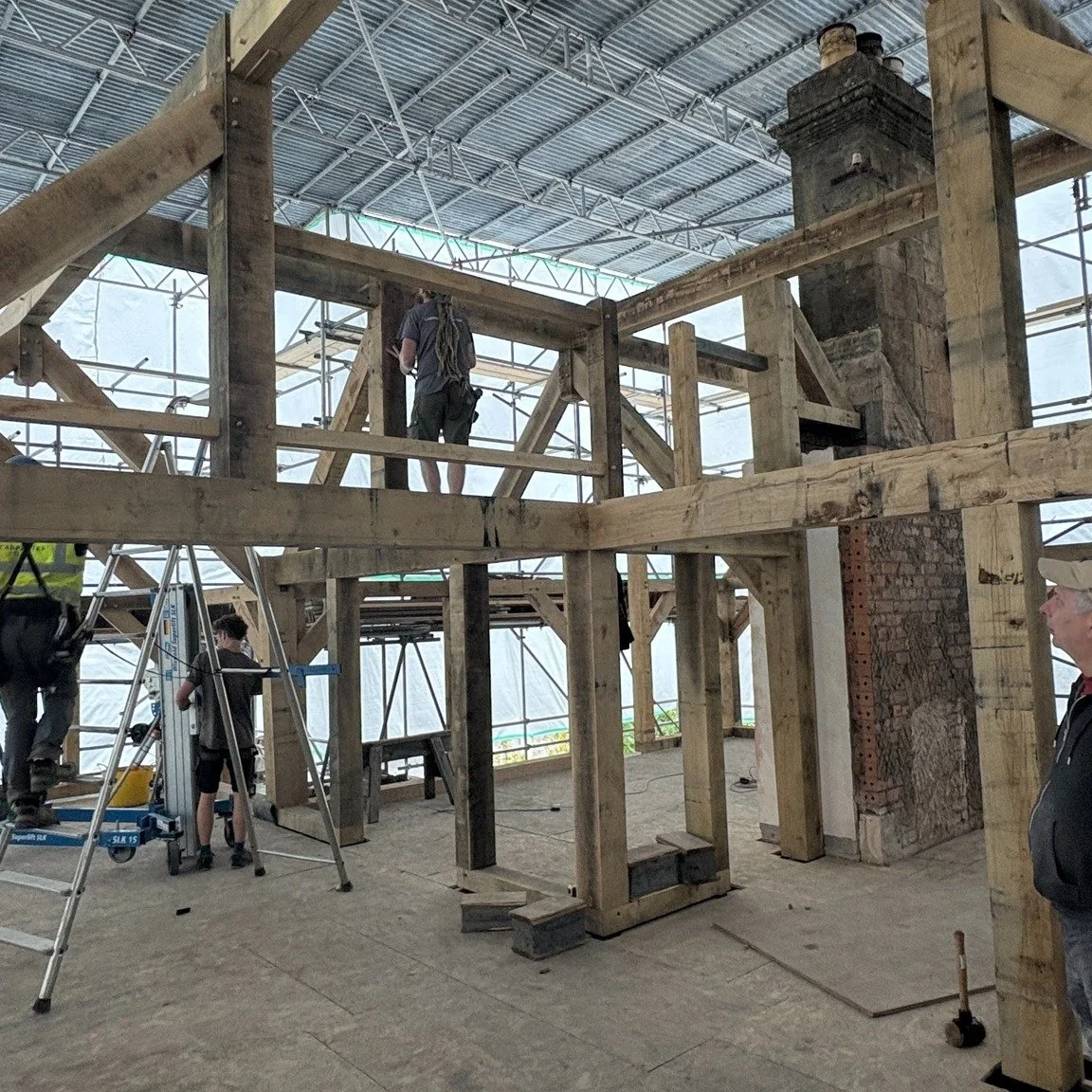 Fantastic to see @carpenter_oak  complete the oak frame on Neill &amp; Ali's project in Bath. Tony from Mayo Masonry has done a great job getting the existing house ready for the frame and was on hand with Neill to knock in an oak peg or two! Pontus 