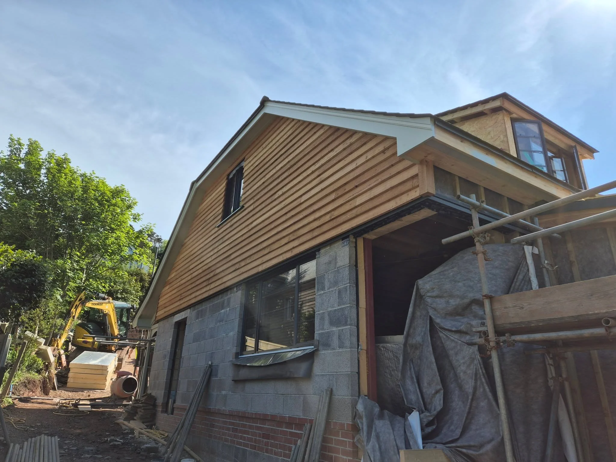 Emerging on site - a complete transformation of a historic seaside bungalow in South Devon. An entirely new roof structure and contemporary green oak frame extension bring this 1920's home into the 21st Century. A Roof-mounted PV panel array, air sou