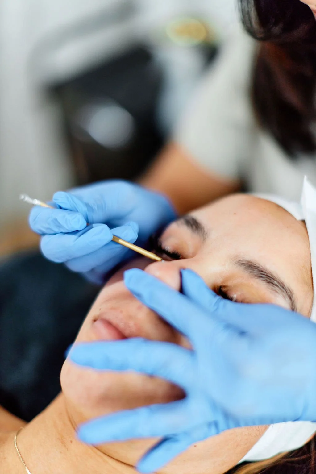 Close-up corrective skincare treatment performed with gloved hands