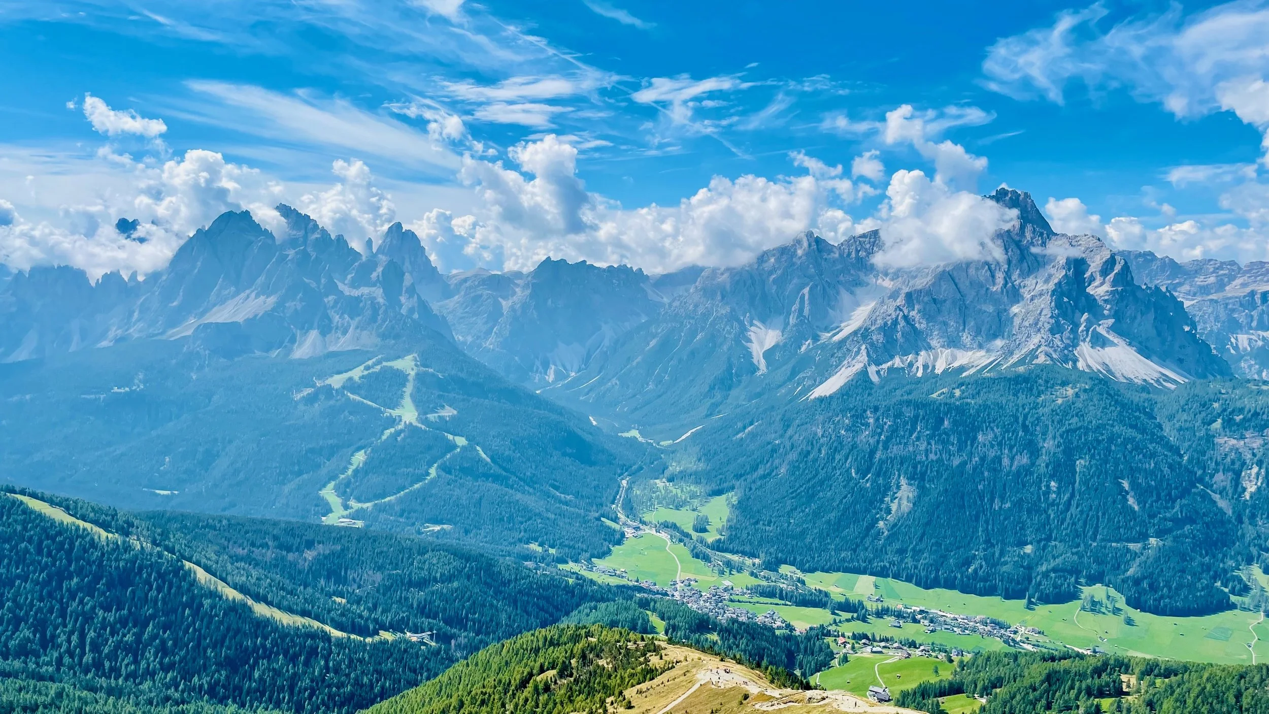 Sesto valley and surrounding Dolomites mountains and clouds
