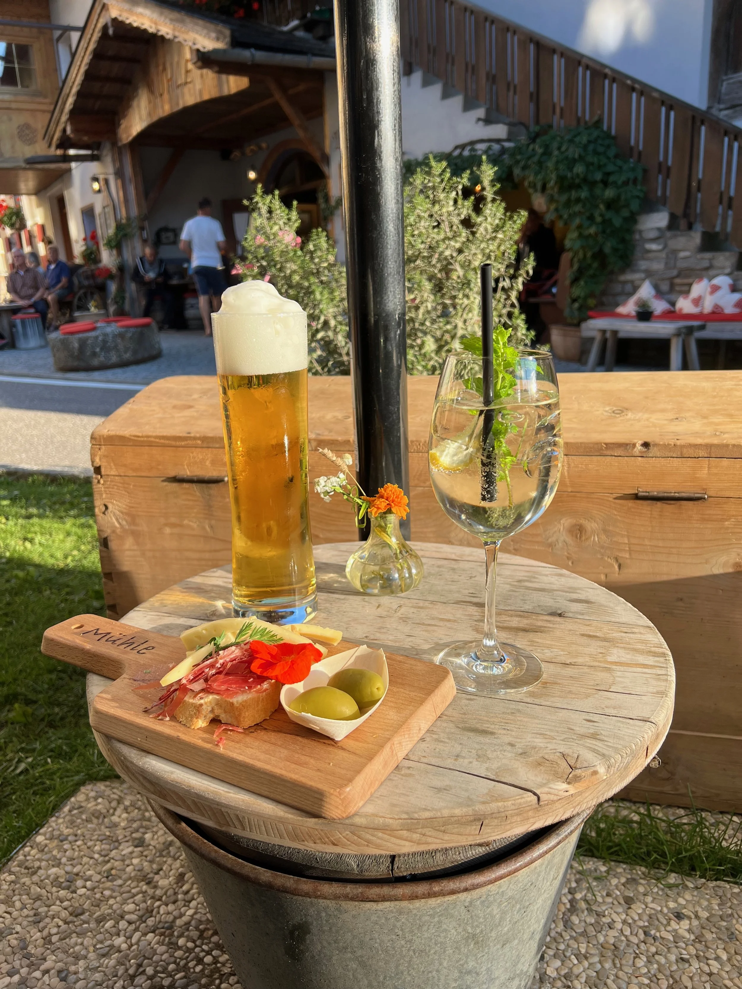 Aperitivo in South Tyrol with wine and snacks on an outdoor table in the mountains