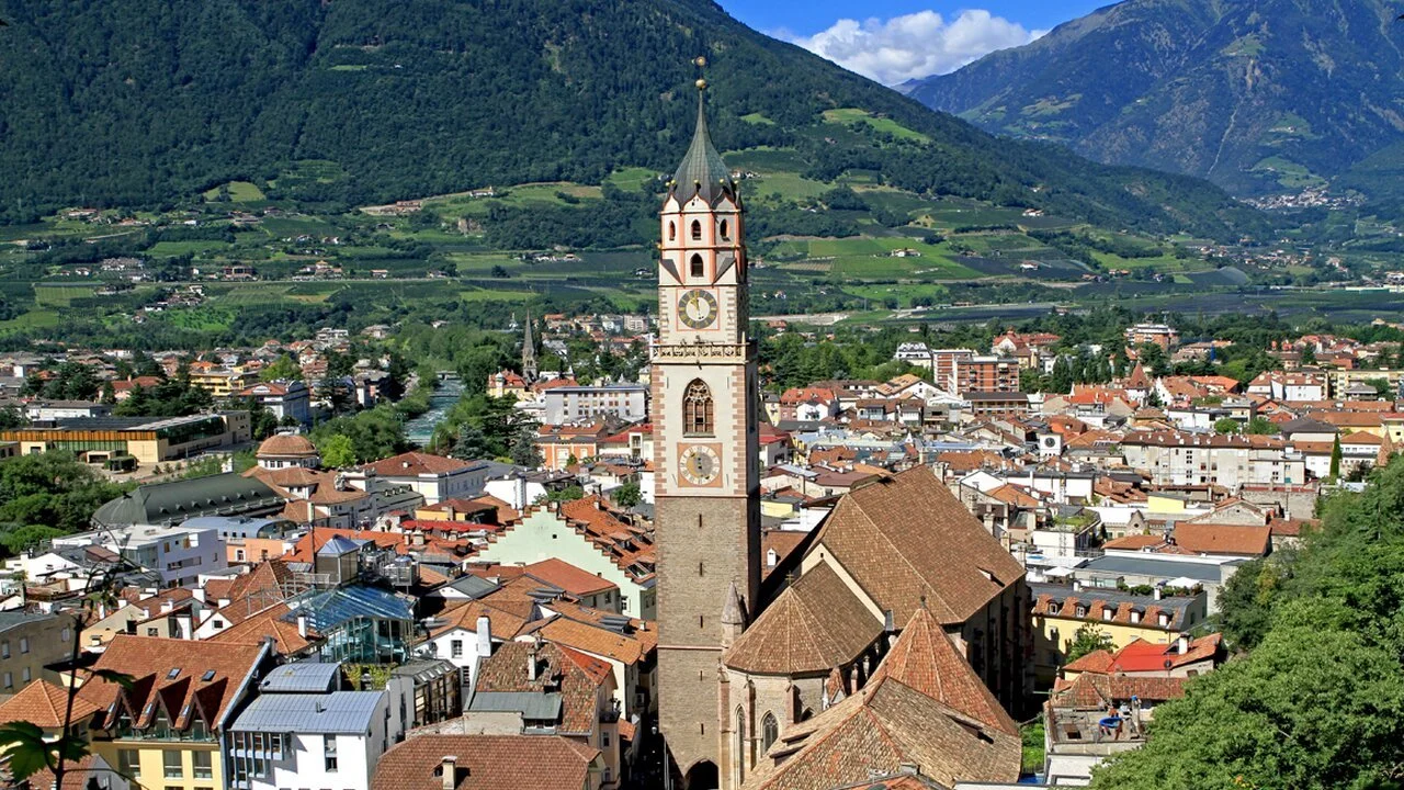 Merano town with palm-lined promenade and mountain backdrop in South Tyrol