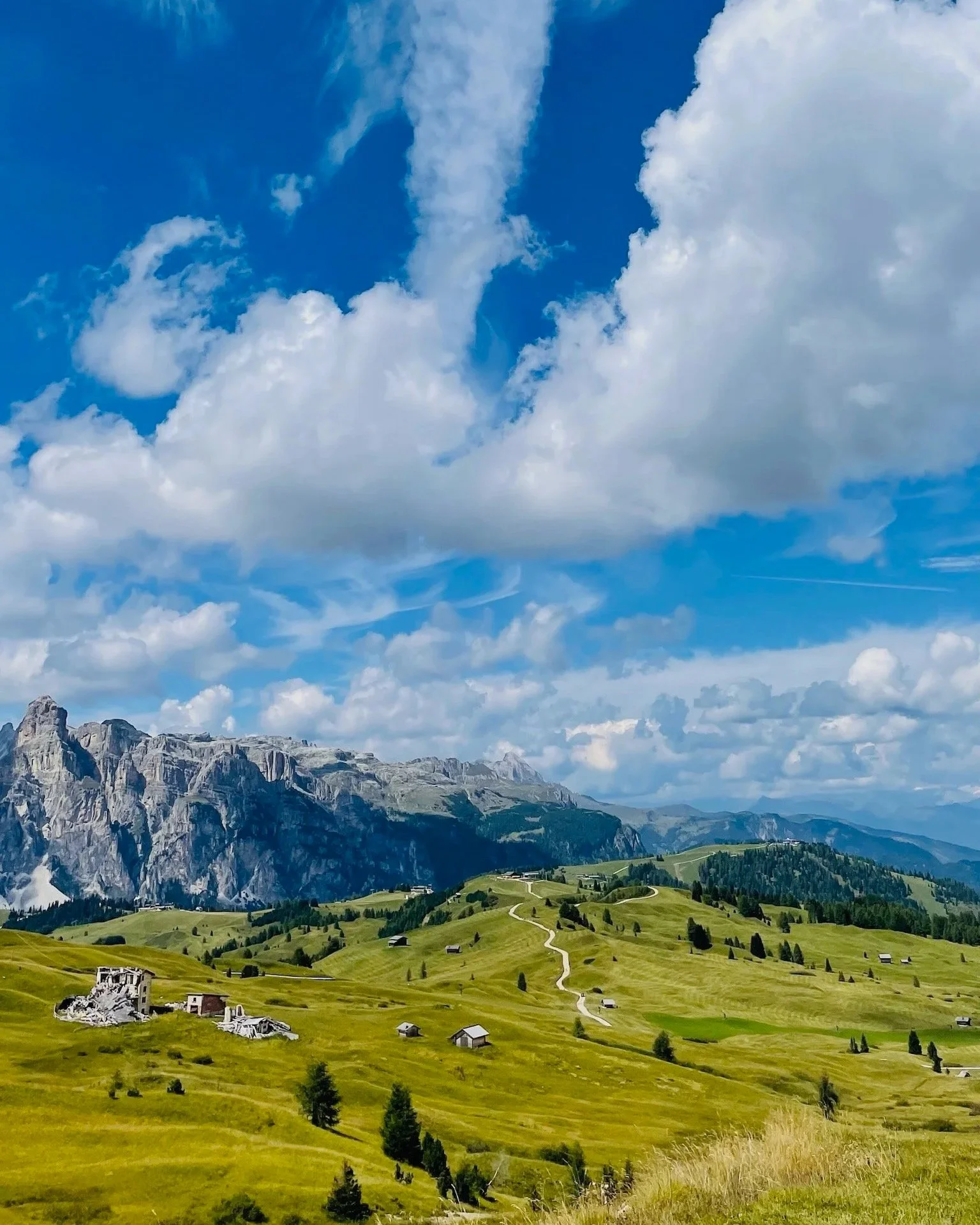 Expansive, wide, Dolomites landscape with road and clouds