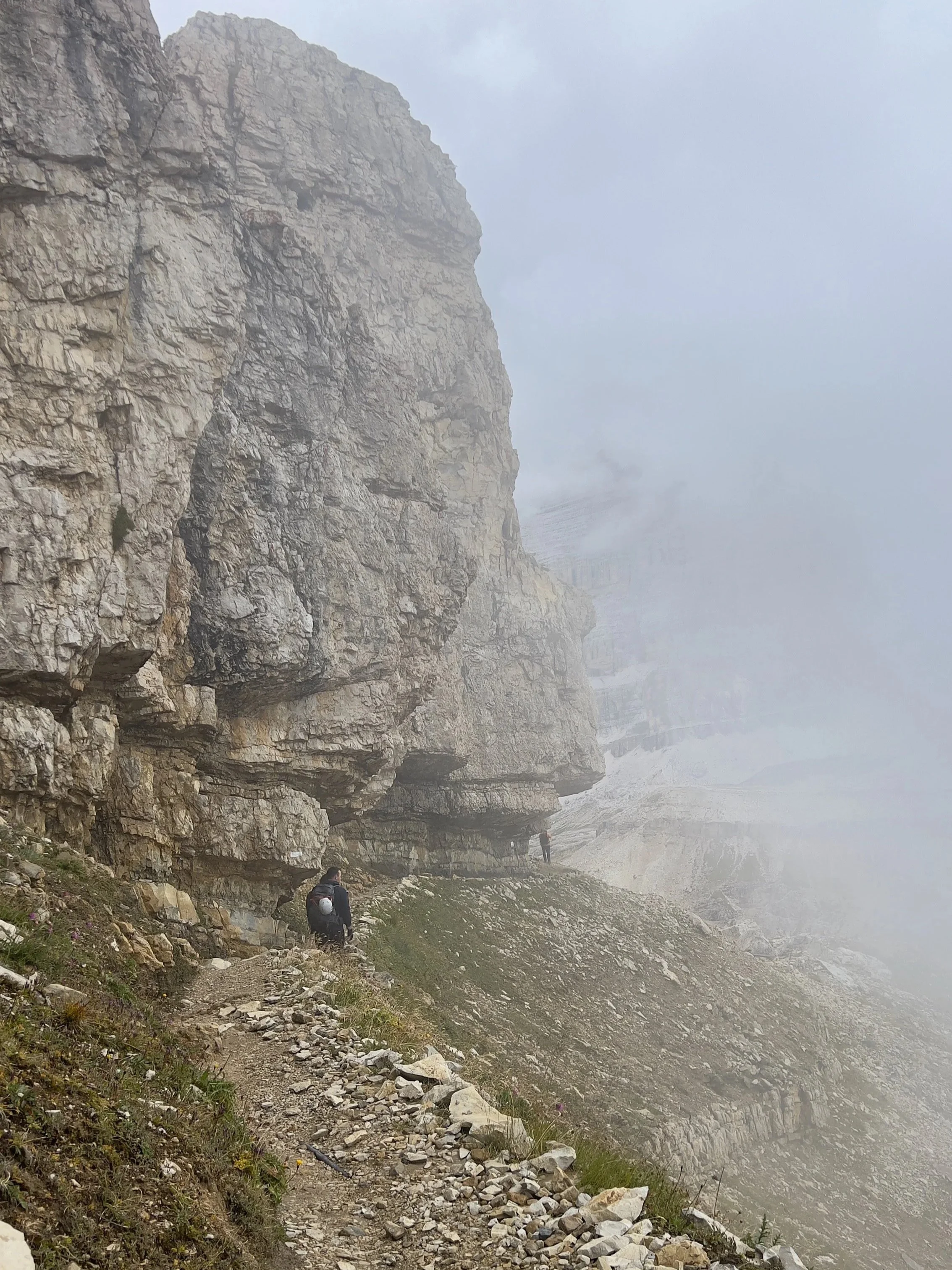 mountain trail in the Dolomites with mist and changing weather conditions