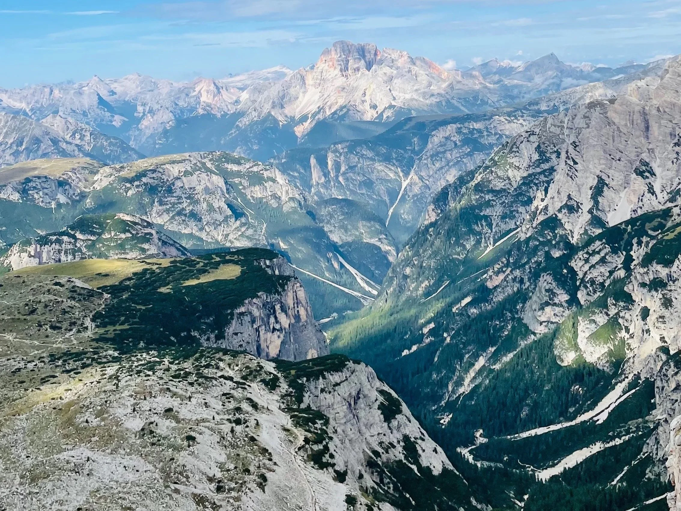 View of the Dolomites mountains from above showing valleys and peaks and used to illustrate planning a Dolomites trip
