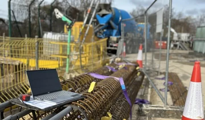 Laptop on reinforcement steel rebar during geotechnical design consultancy work on site.