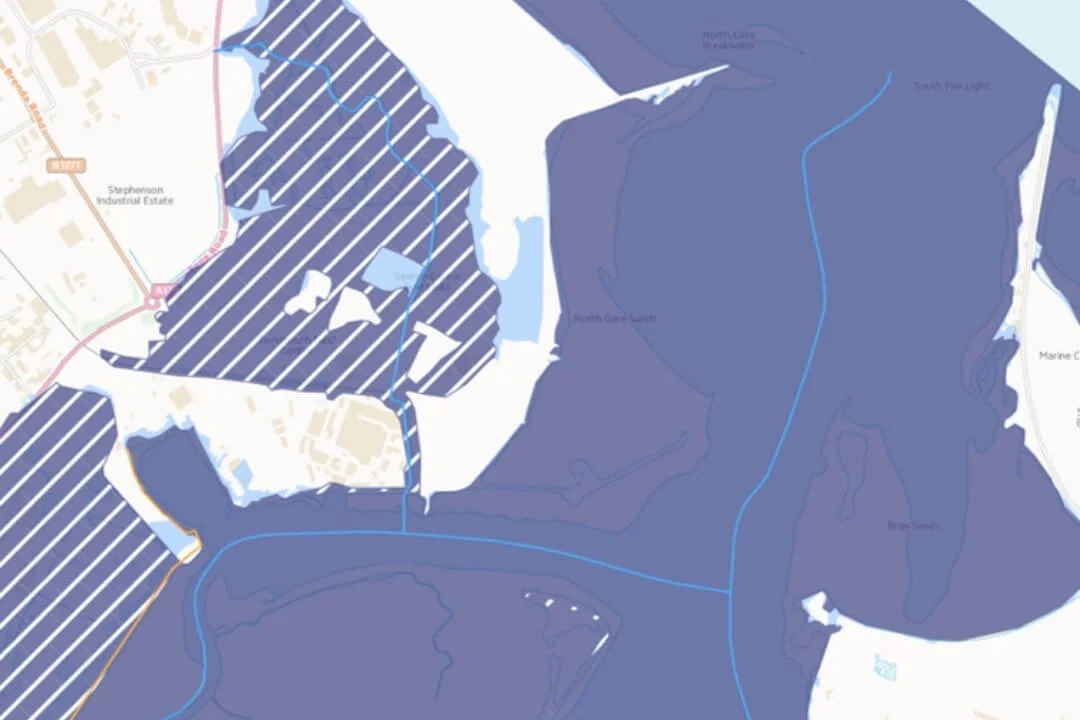 Flood risk map showing tidal zones, defences and watercourses used for desk-based screening in a Phase 1 Desk Study.